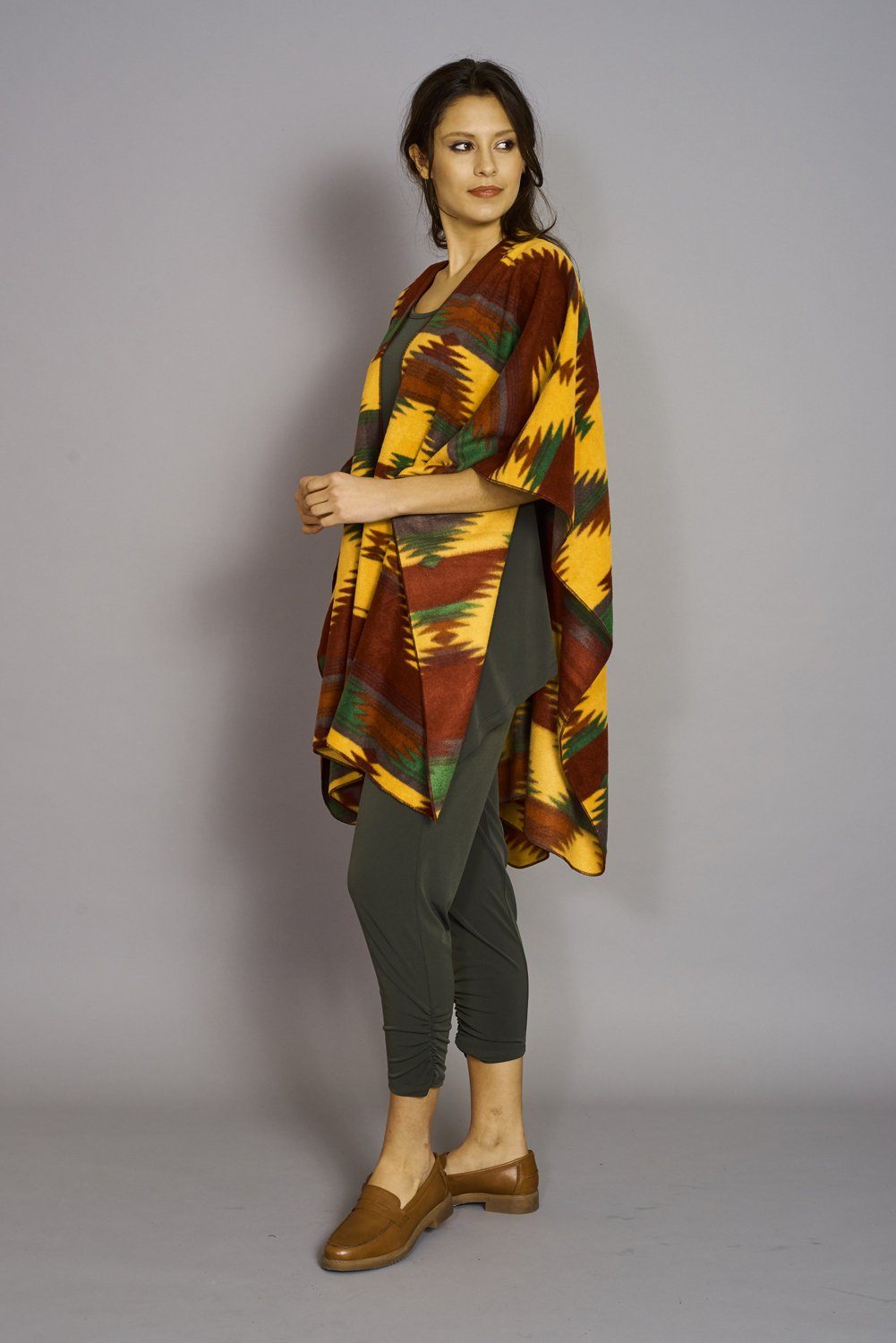 Navaho Print Premium Mountain Fleece Cape displayed elegantly, showcasing its buffalo plaid design and cozy texture.