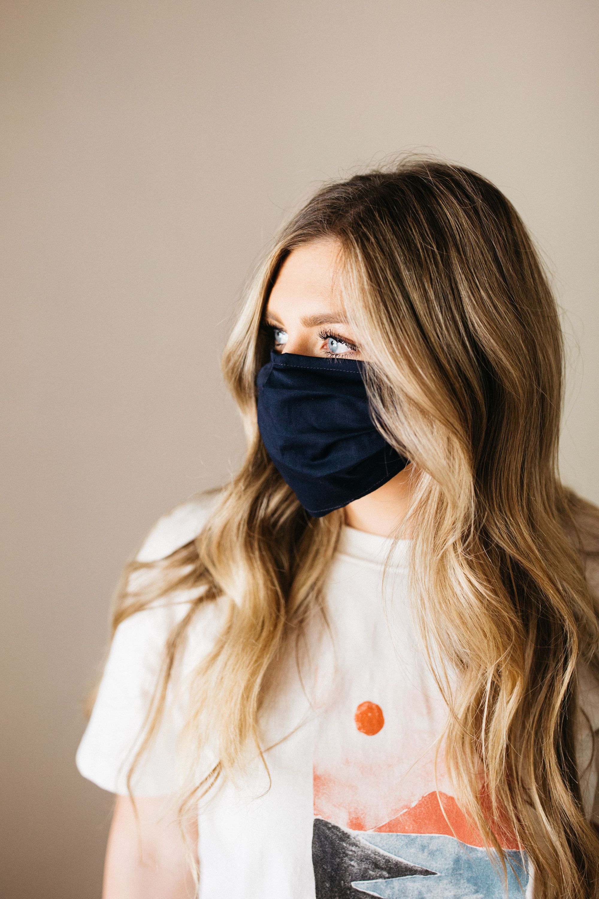 Navy face mask made of 100% cotton with pleats and filter pocket, designed for comfort and style.