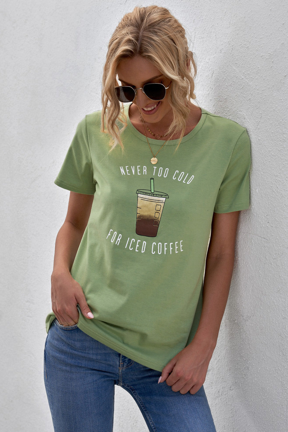 A soft and stylish Never Too Cold for Iced Coffee Tee in various colors, featuring a crew neck and short sleeves.