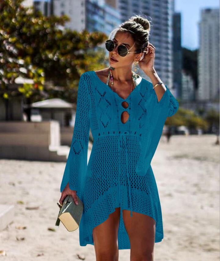 A stylish crochet beach cover-up for women featuring knitted tassels, available in multiple colors including orange, black, white, green, blue, and wine.