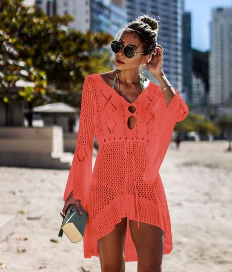 A stylish crochet beach cover-up for women featuring knitted tassels, available in multiple colors including orange, black, white, green, blue, and wine.