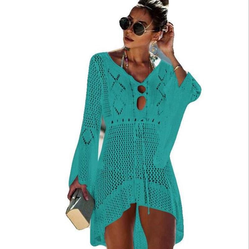 A stylish crochet beach cover-up for women featuring knitted tassels, available in multiple colors including orange, black, white, green, blue, and wine.