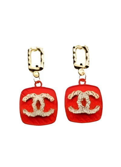 A pair of elegant earrings featuring a stylish CC design in vibrant red and blue colors, perfect for any occasion.