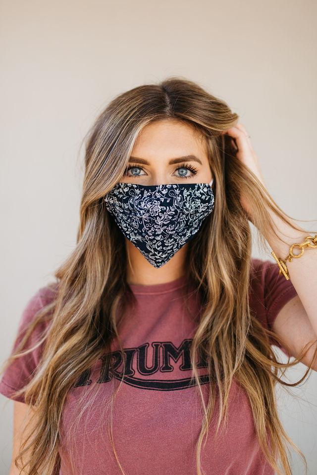 Normandy Floral Face Mask featuring a colorful floral pattern, made from 100% cotton with elastic ear straps and a pocket for filters.