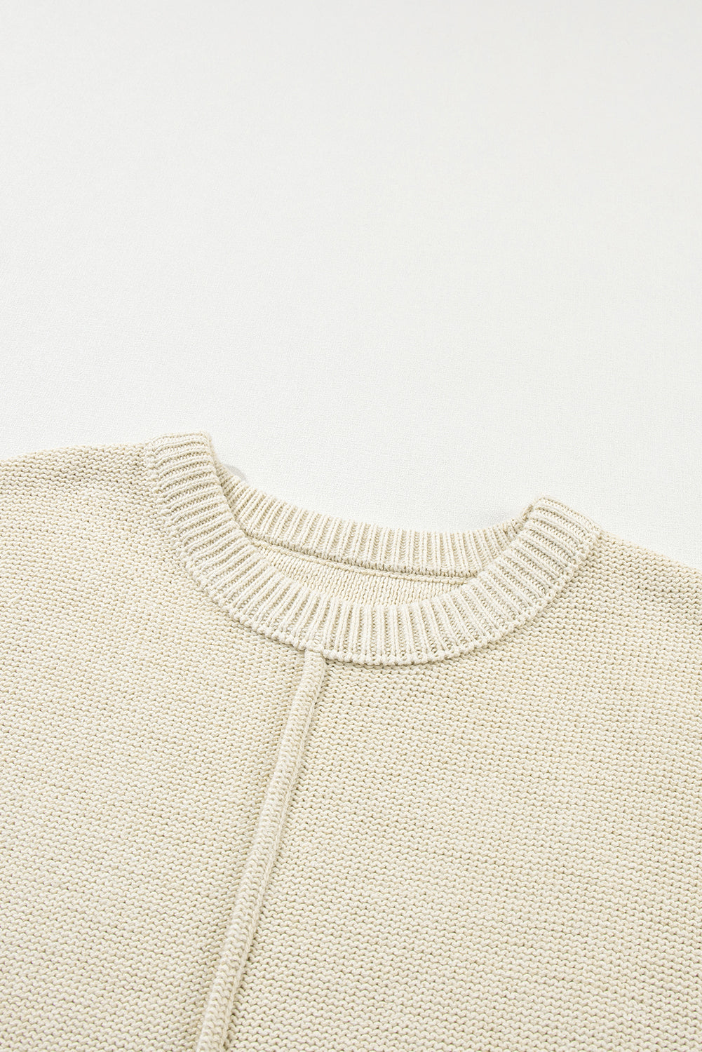 Oatmeal solid color cap sleeve knitted sweater displayed on a mannequin, showcasing its stylish design and soft fabric.