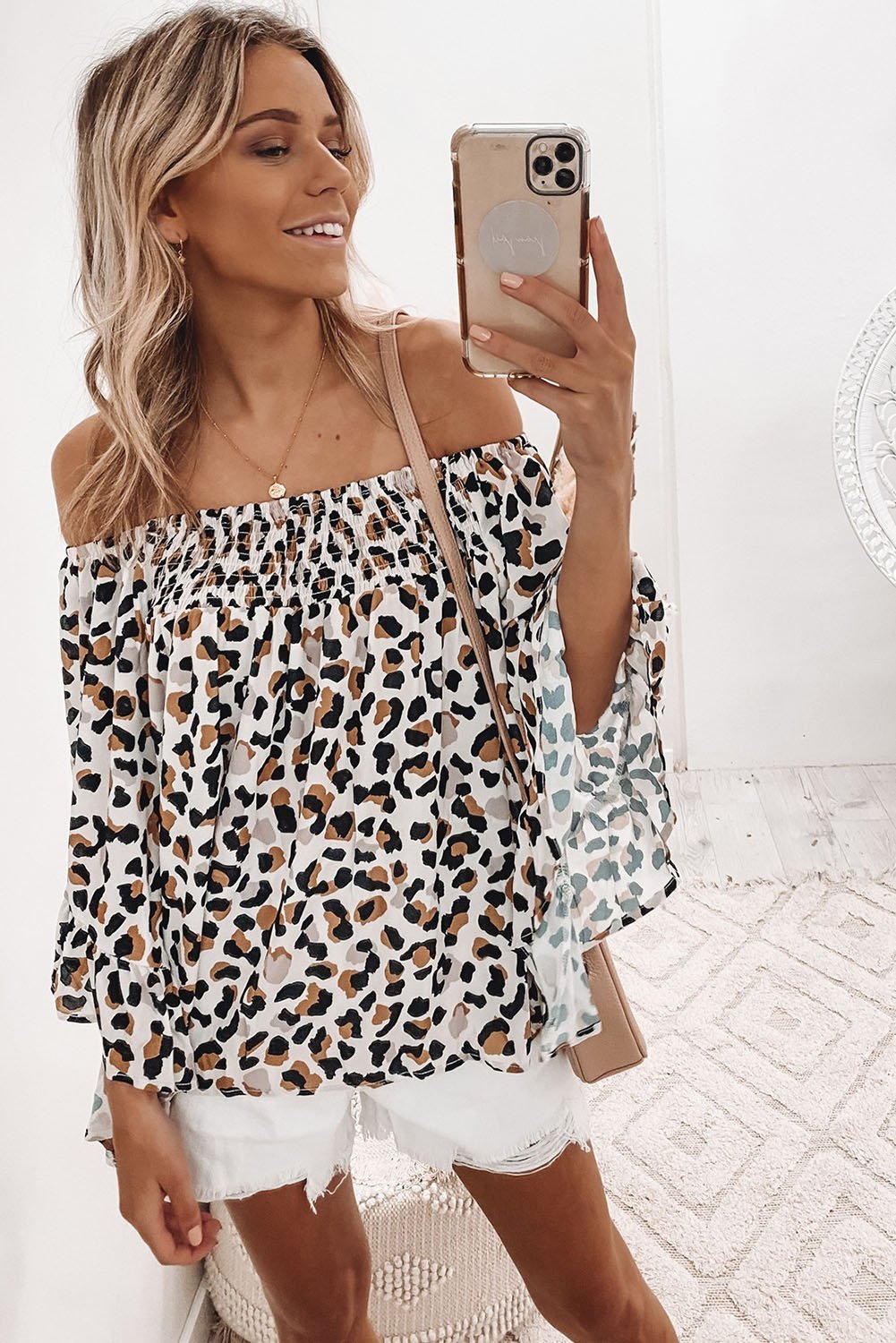 A stylish Off Shoulder Flared Sleeve Top featuring a wild animal pattern and flared sleeves, perfect for casual outings.