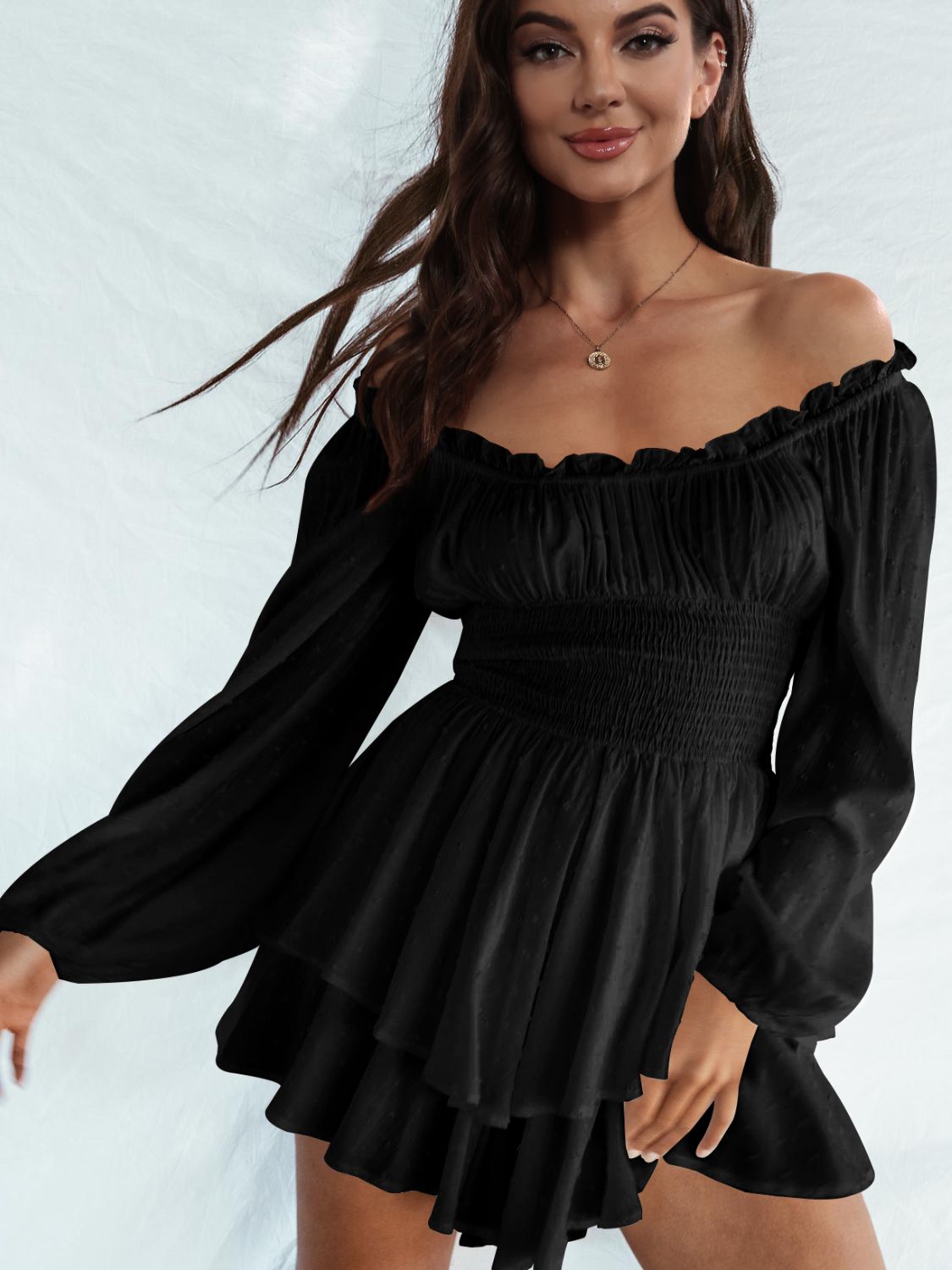 A stylish off-shoulder mini dress with a smocked waist and layered hem, featuring long sleeves and a solid pattern, perfect for casual outings.