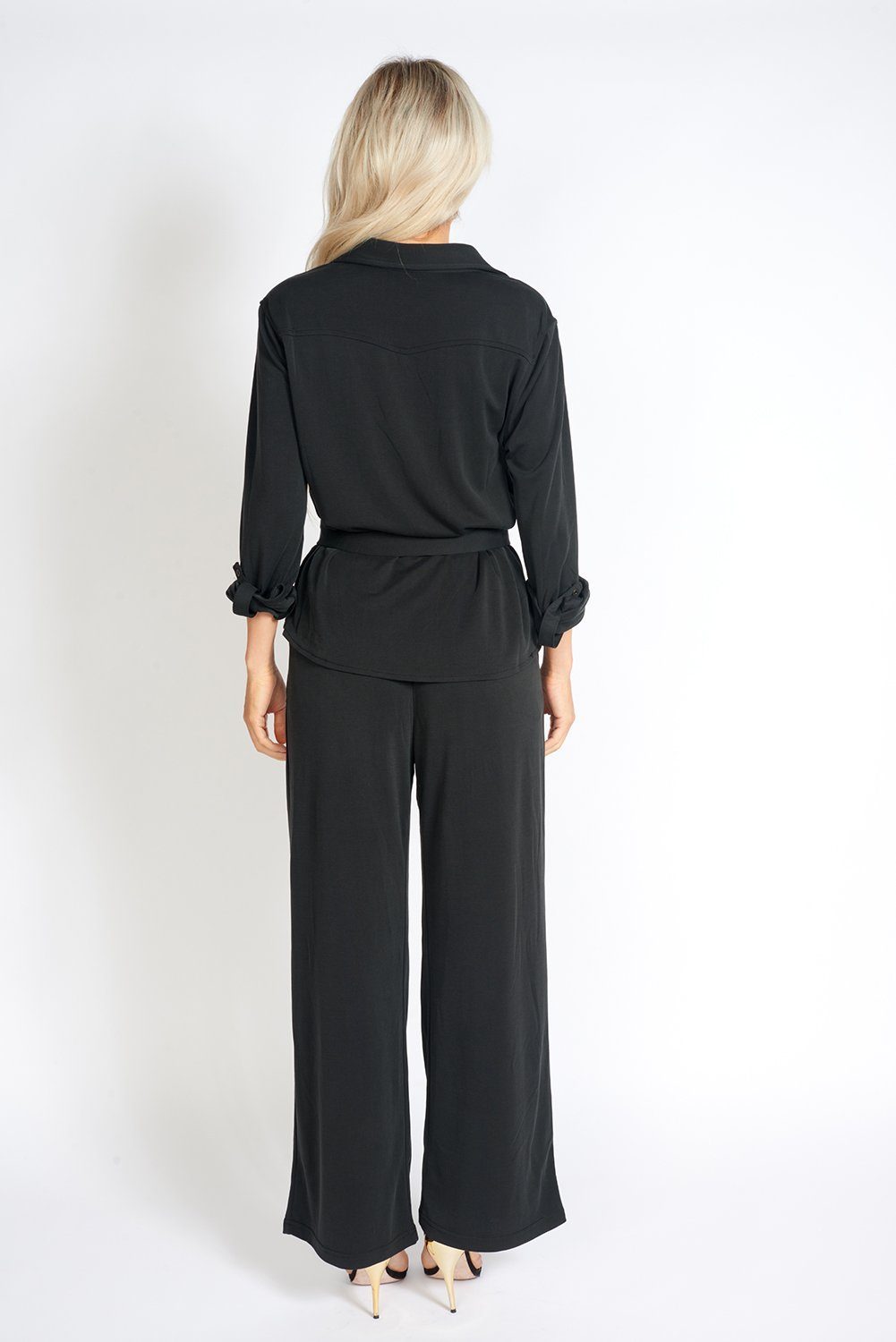 A pair of stylish black wide leg pants with an elasticized waist, showcasing a soft fabric and loose fit, ideal for office wear.