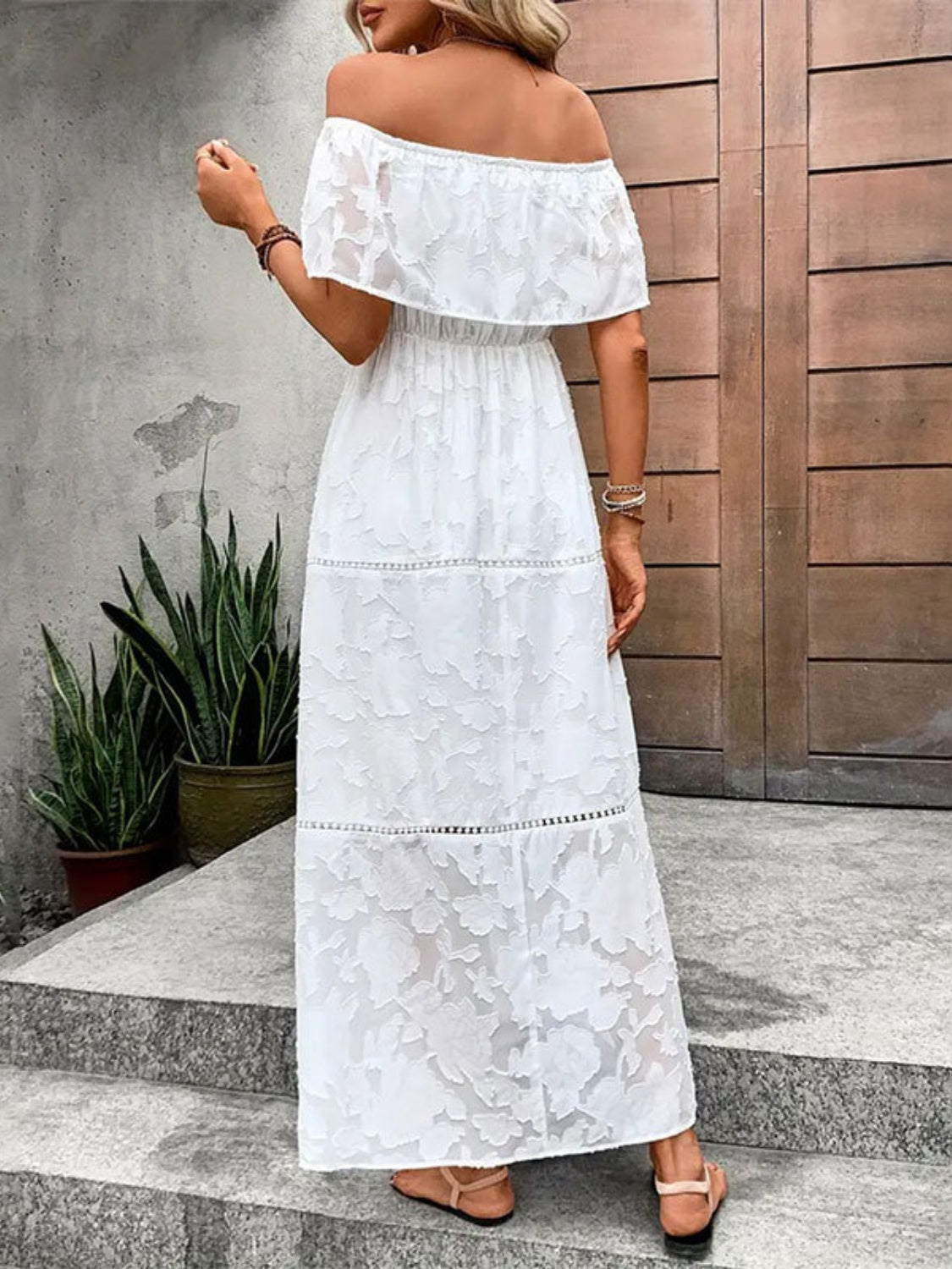 A stylish off-shoulder short sleeve maxi dress in a light fabric, perfect for summer occasions.