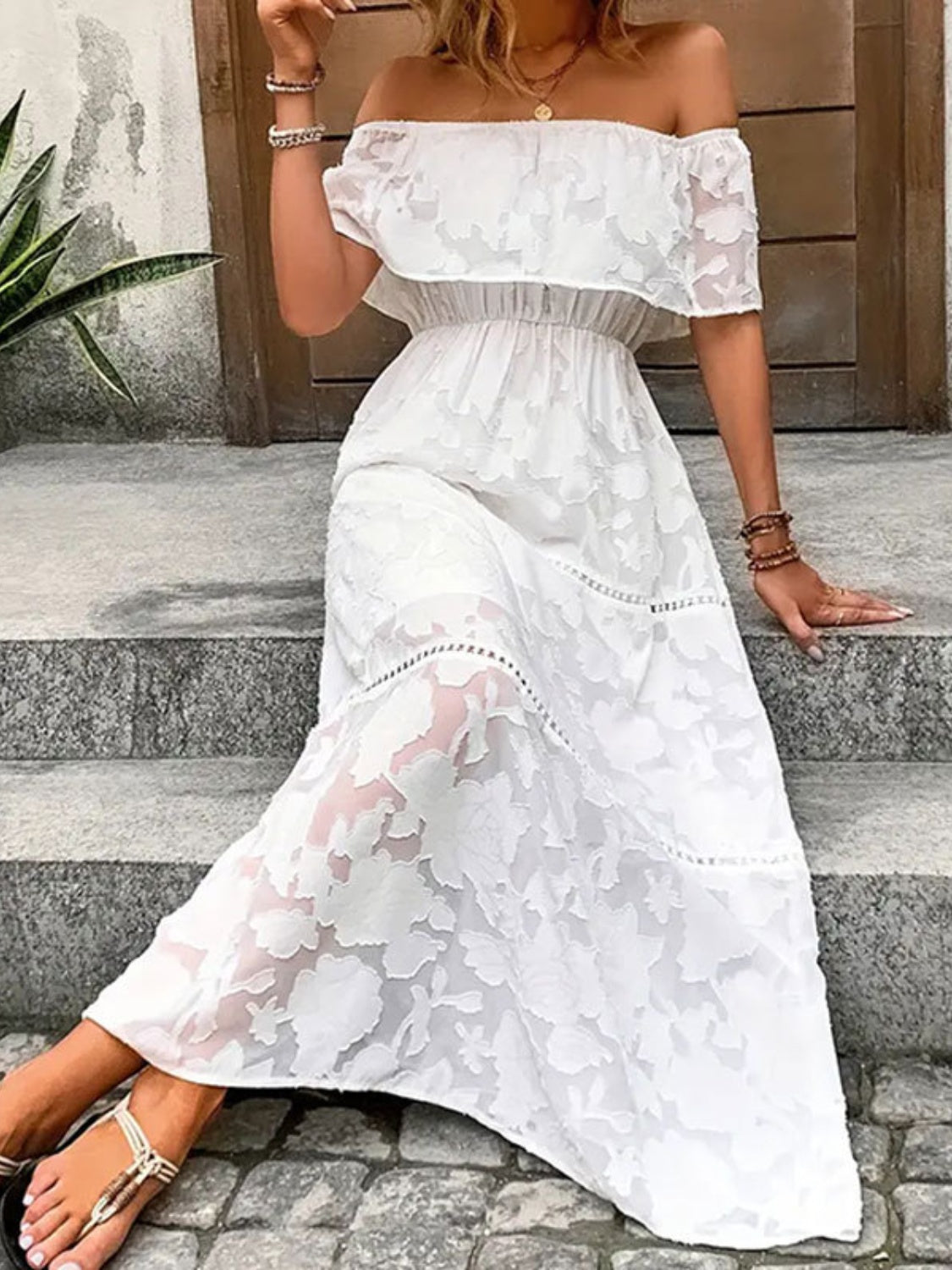 A stylish off-shoulder short sleeve maxi dress in a light fabric, perfect for summer occasions.