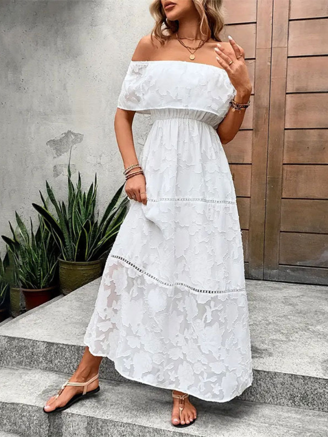 A stylish off-shoulder short sleeve maxi dress in a light fabric, perfect for summer occasions.