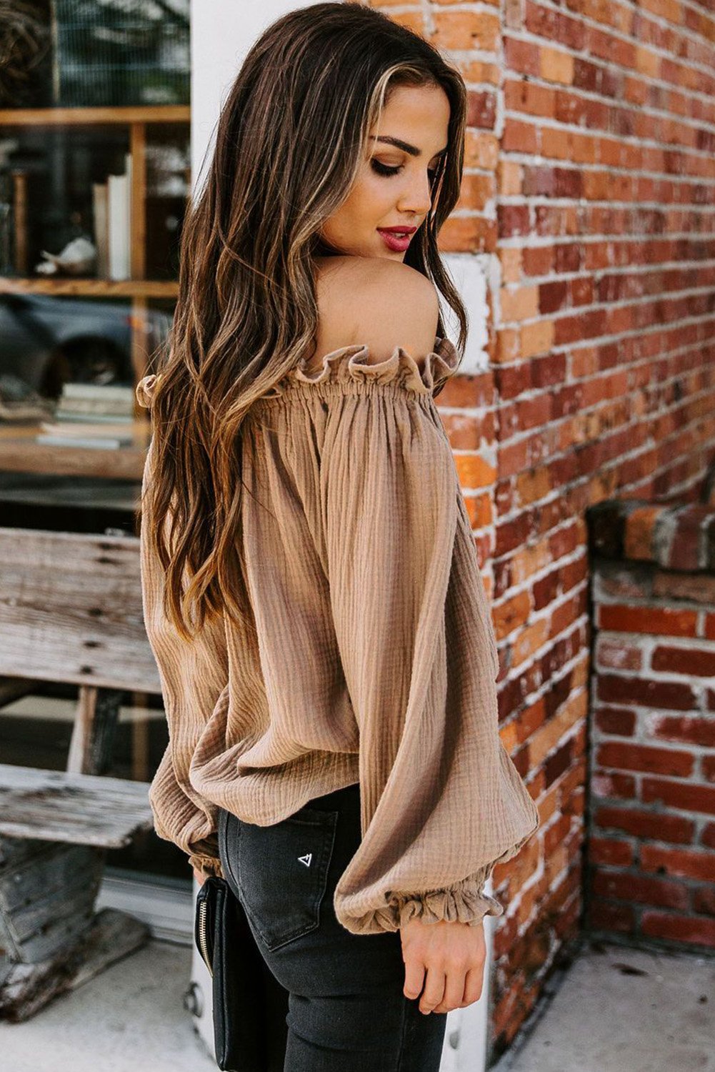 A stylish Off-the-shoulder Ruffle Top featuring an elastic ruffled neckline and flowy sleeves, perfect for casual or dressy occasions.