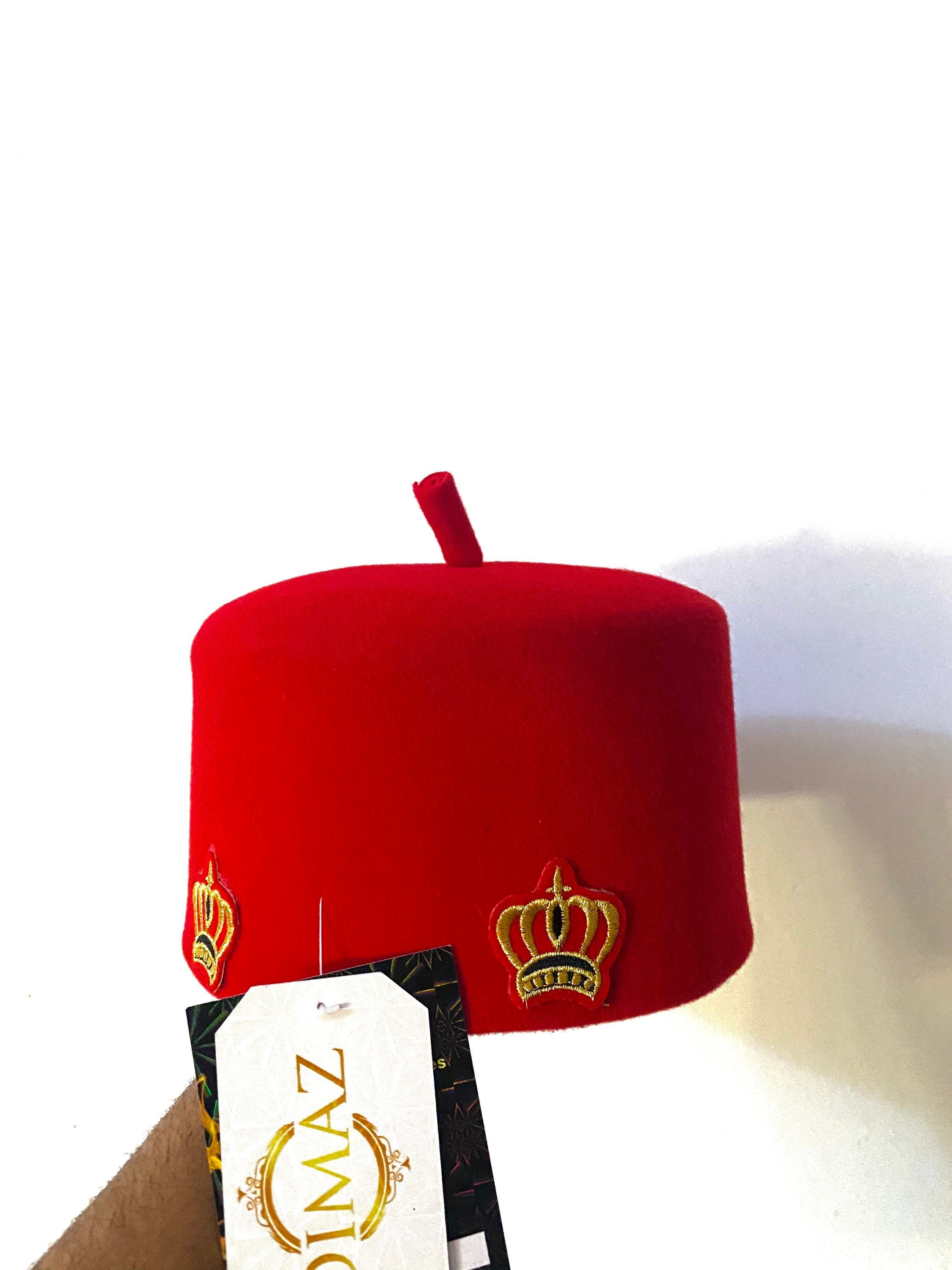 Ome Ego red cap with crown stamps, symbolizing Igbo authority and tradition, crafted from Czech wool.