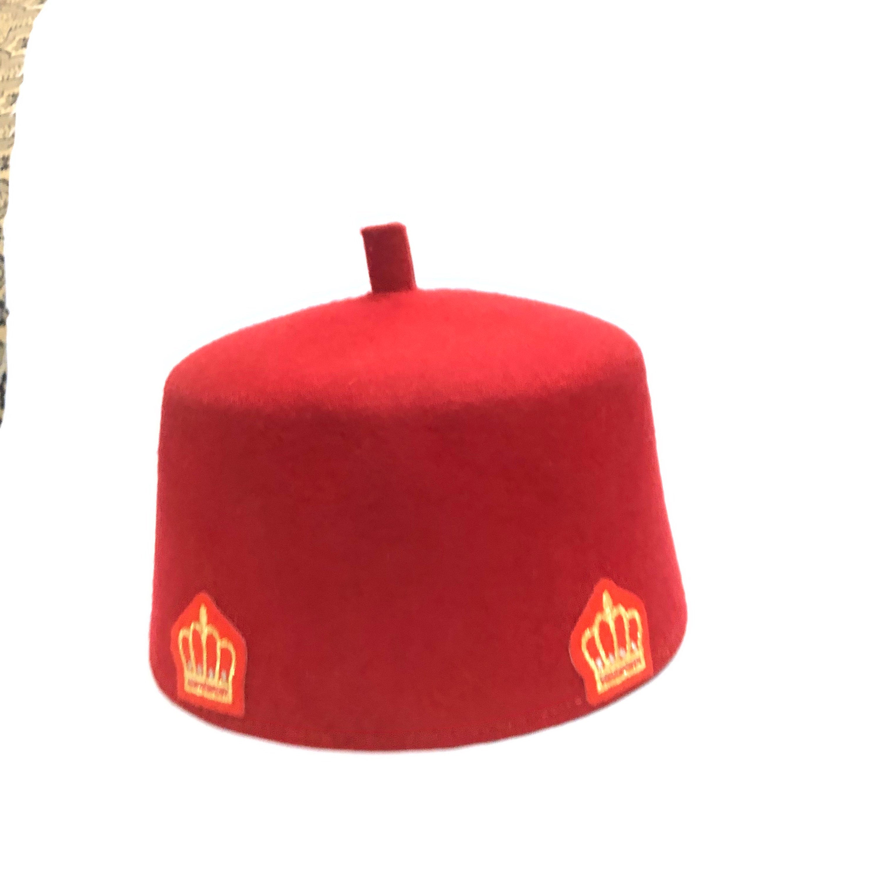 Ome Ego red cap with crown stamps, symbolizing Igbo authority and tradition, crafted from Czech wool.