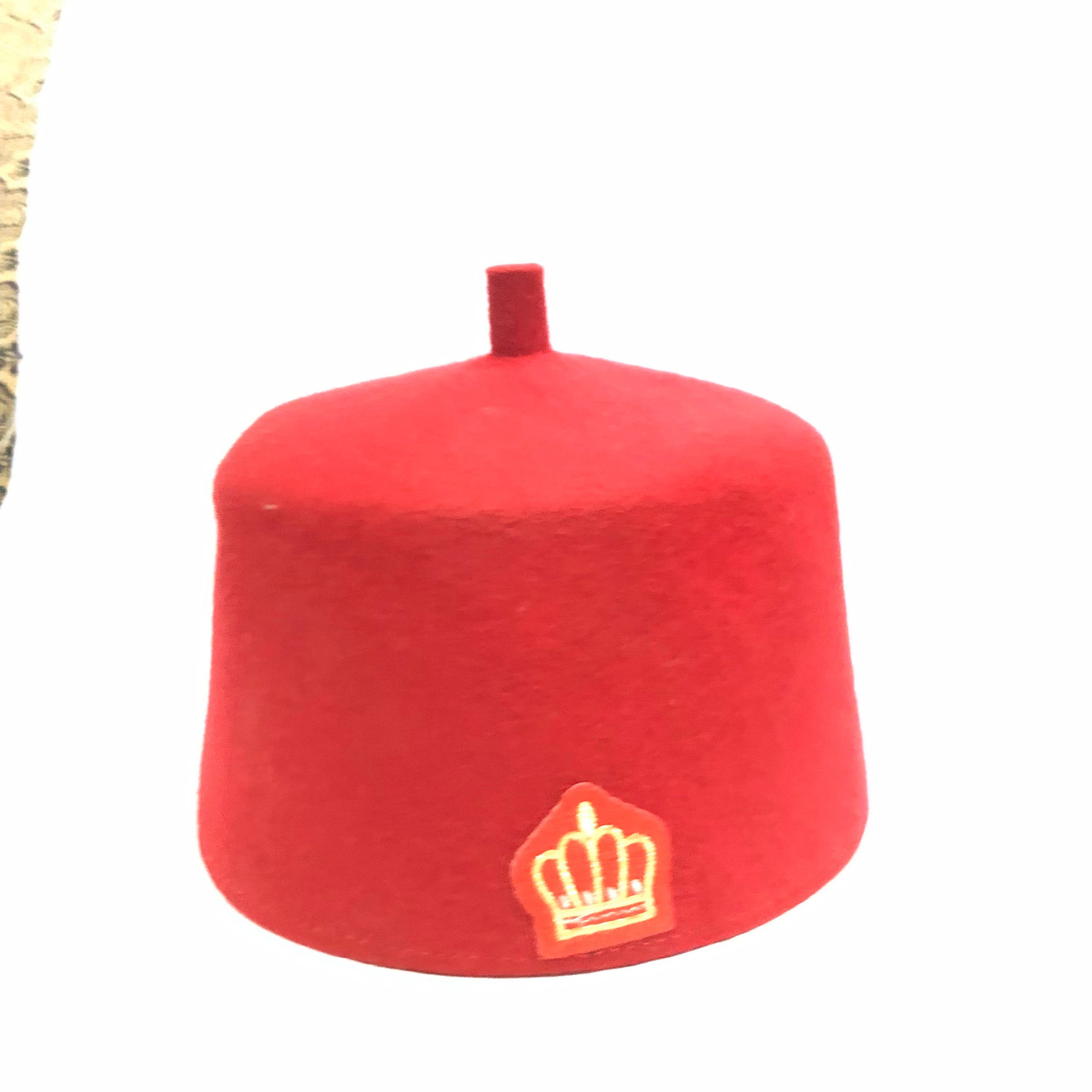 Ome Ego red cap with crown stamps, symbolizing Igbo authority and tradition, crafted from Czech wool.