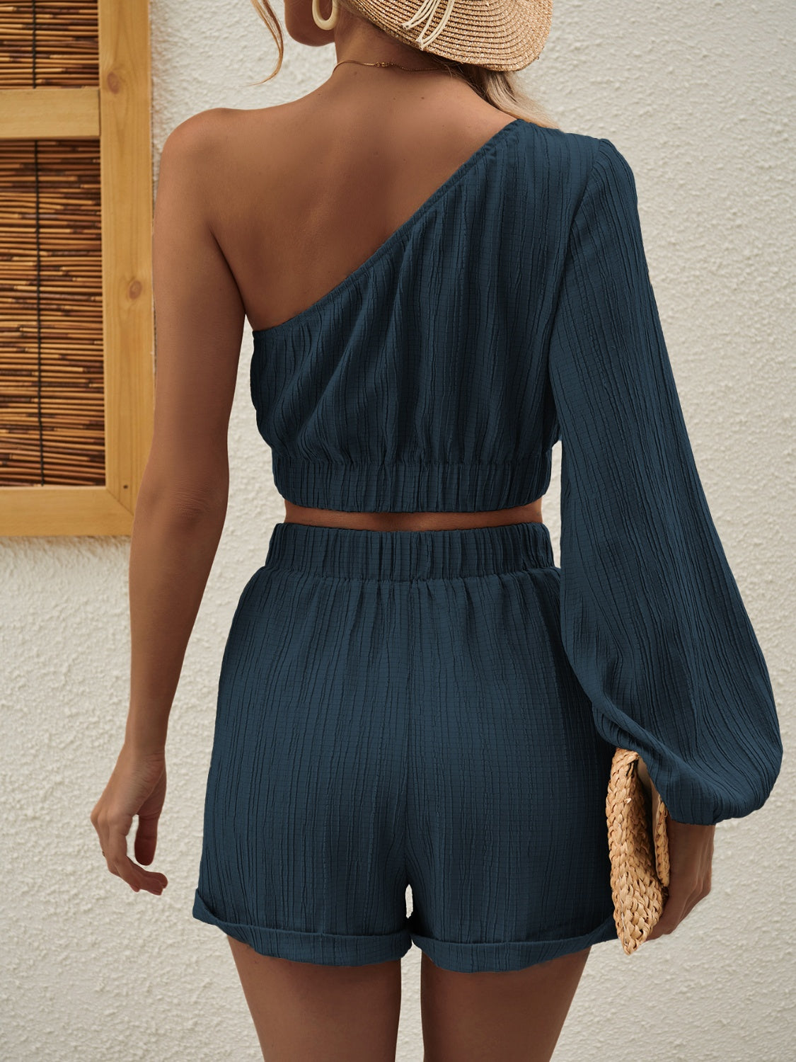 One Shoulder Long Sleeve Top and Shorts Set displayed on a mannequin, showcasing its stylish design and fabric texture.