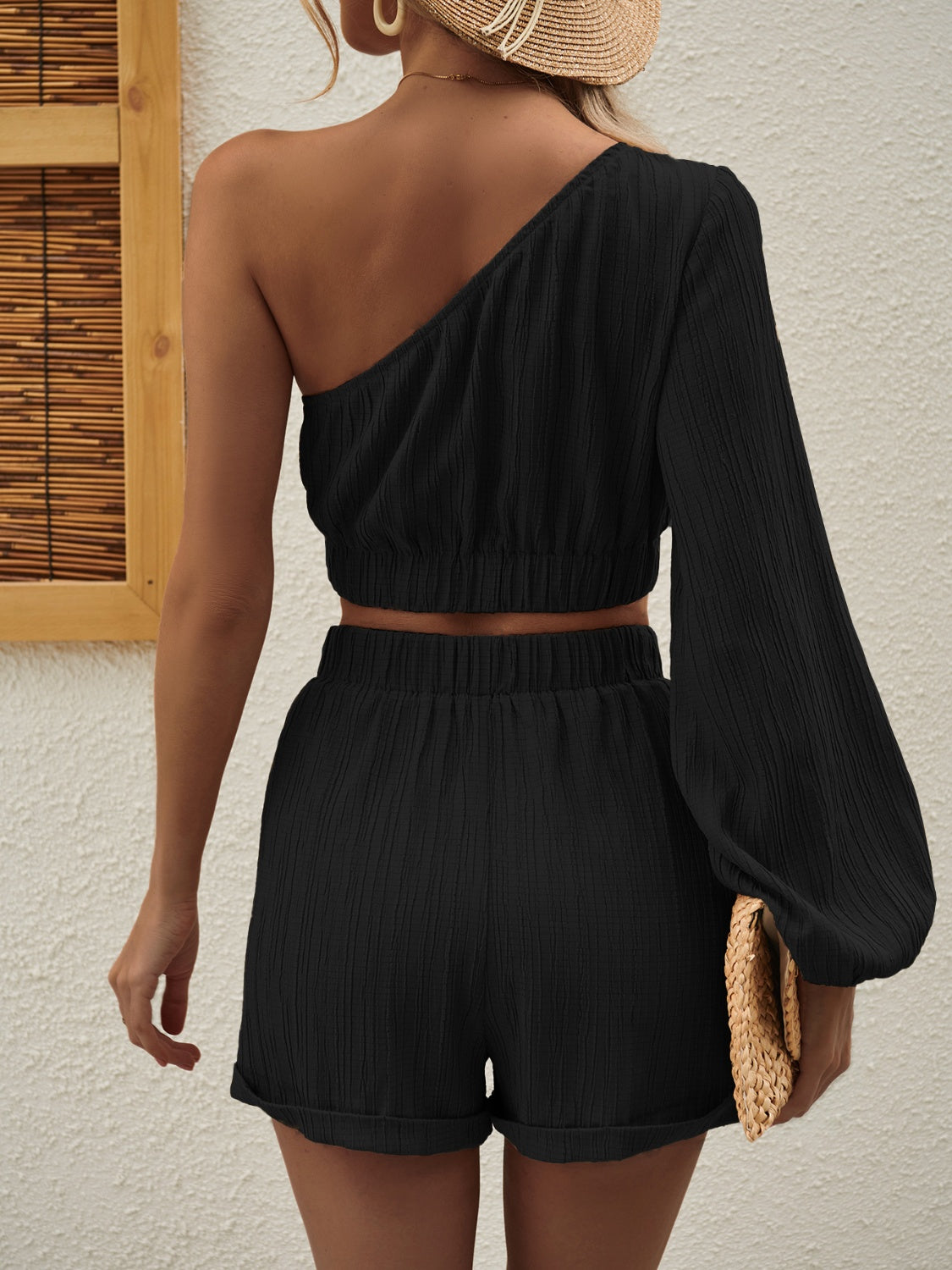 One Shoulder Long Sleeve Top and Shorts Set displayed on a mannequin, showcasing its stylish design and fabric texture.