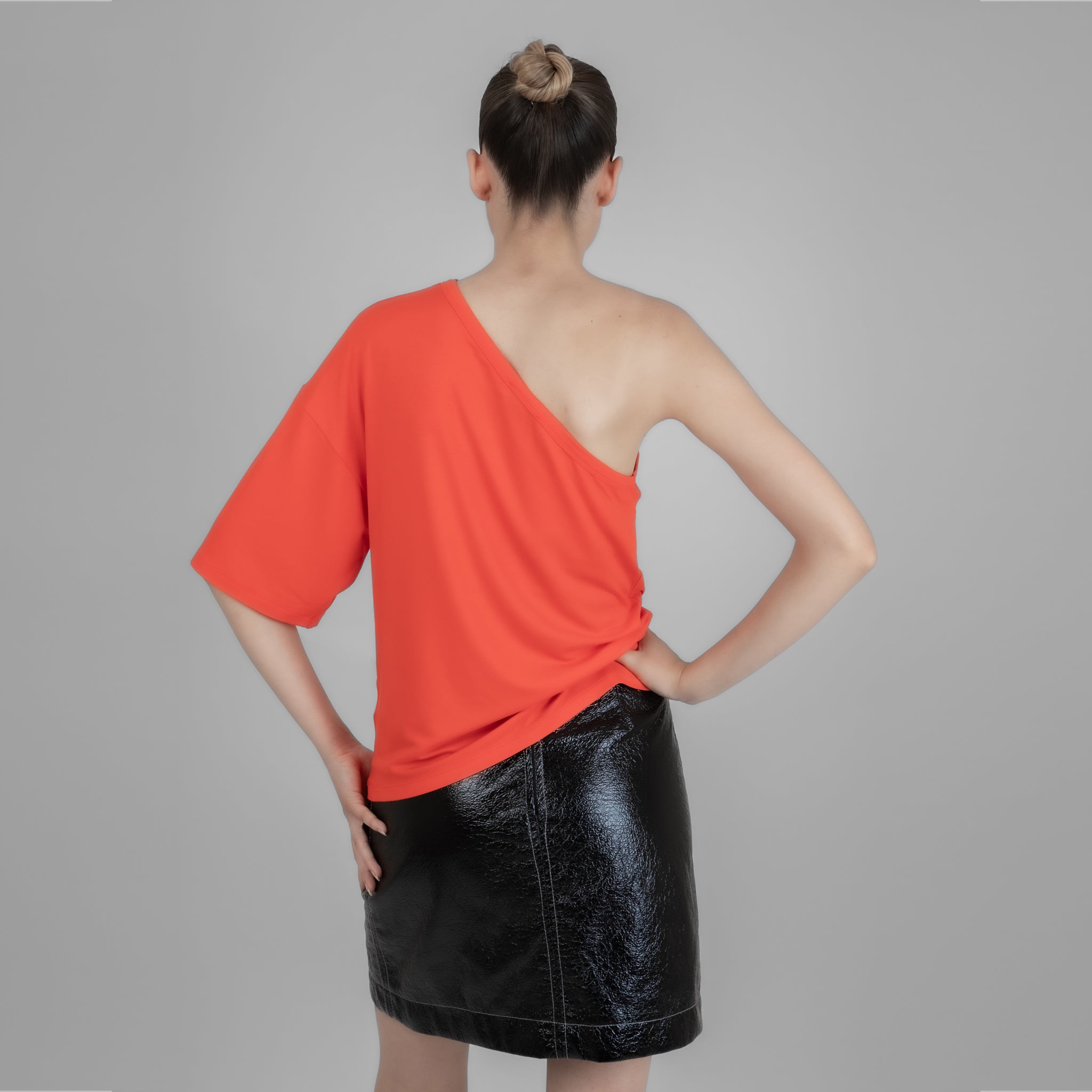 A stylish one shoulder red top made from cotton and elastane, showcasing a trendy design perfect for various occasions.