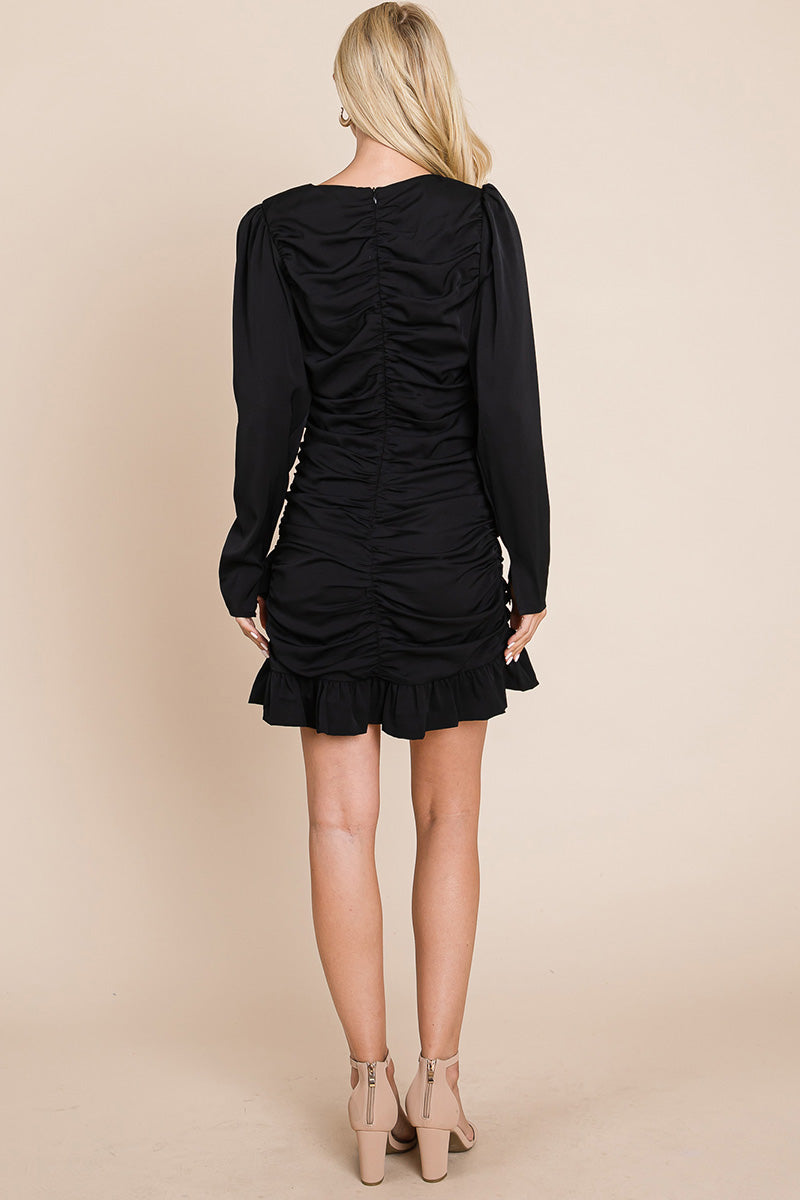 A stylish long sleeve mini dress featuring ruched sides, a boat neck, and a frill hem, perfect for various occasions.