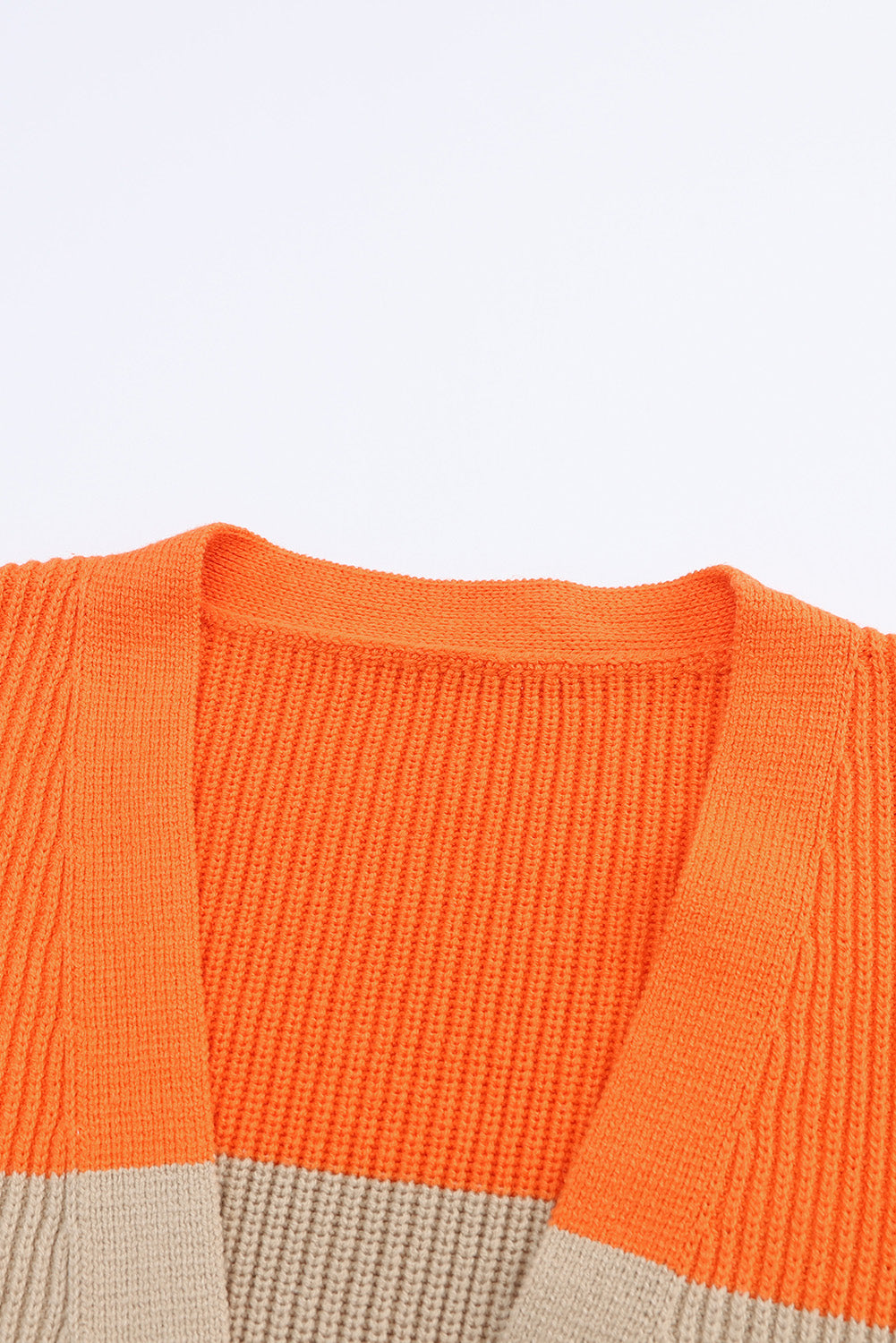 Orange Colorblock Ribbed Knit Cardigan displayed on a mannequin, showcasing its trendy design and soft ribbed fabric.