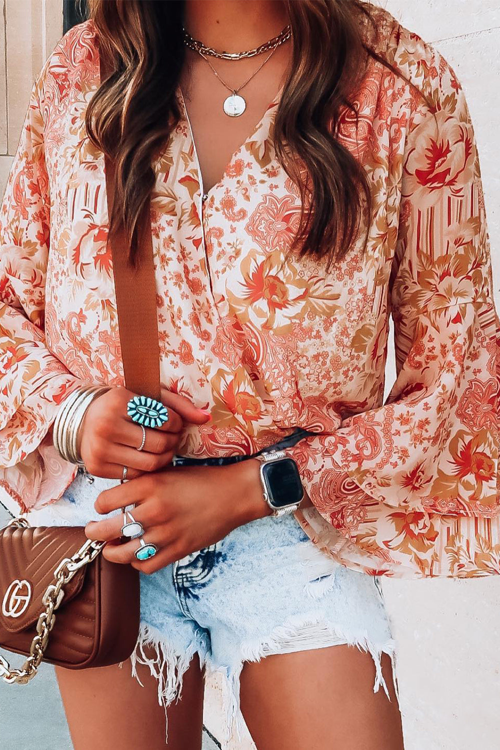 Orange floral print bodysuit featuring ruffled bell sleeves and a V-neckline, perfect for casual outings.