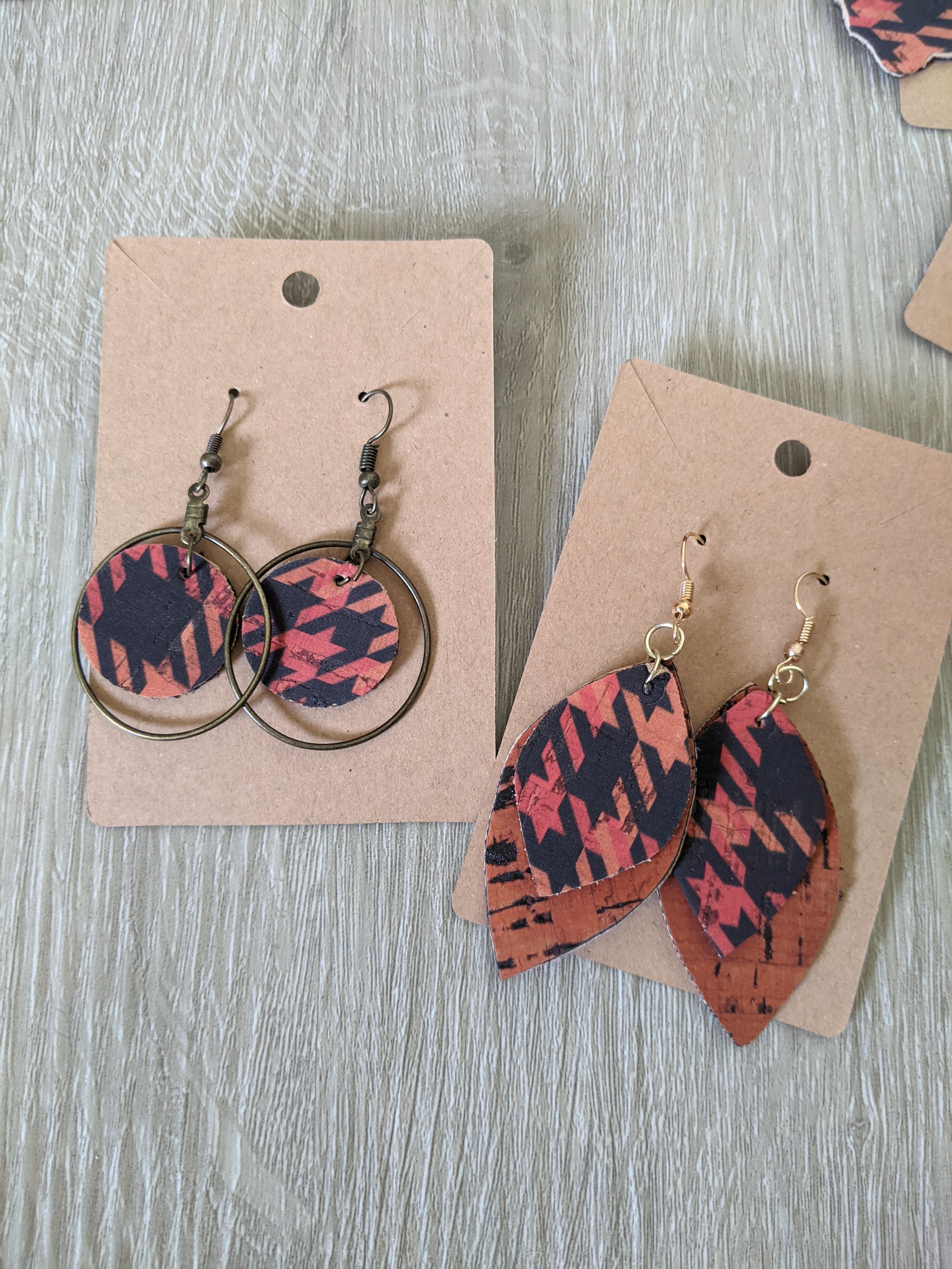 Handmade orange and black houndstooth earrings made from lightweight cork, featuring a trendy reversible design.