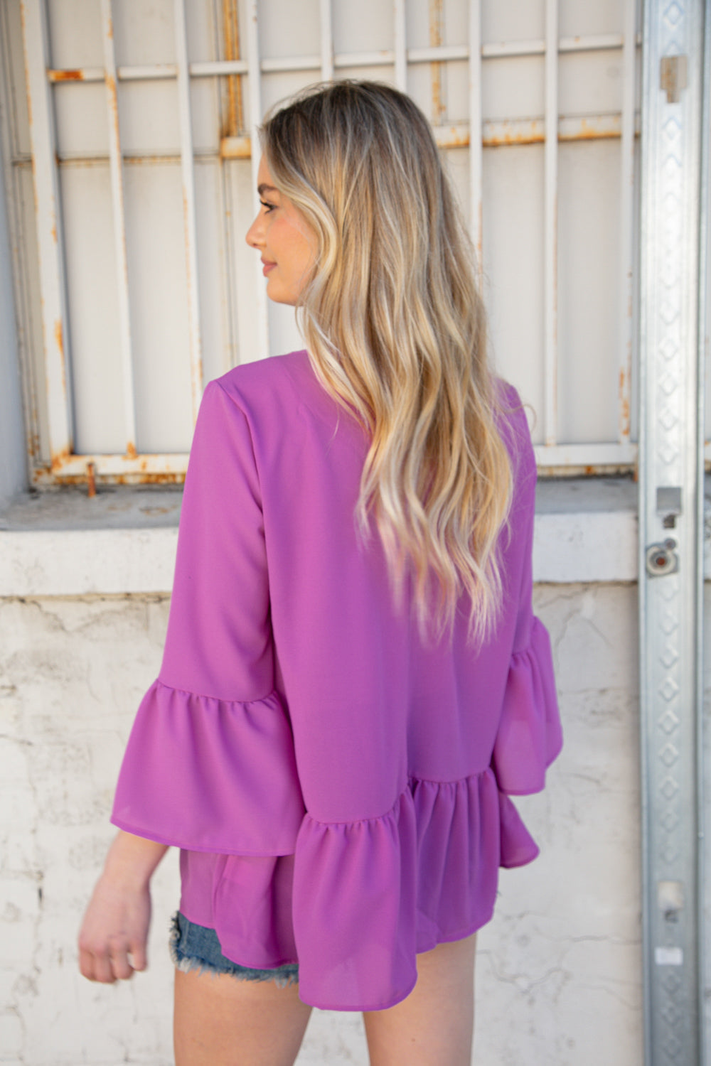 Orchid Round Neck Frill Detail Crepe Blouse featuring a frill yoke and bell sleeves, perfect for stylish outings.