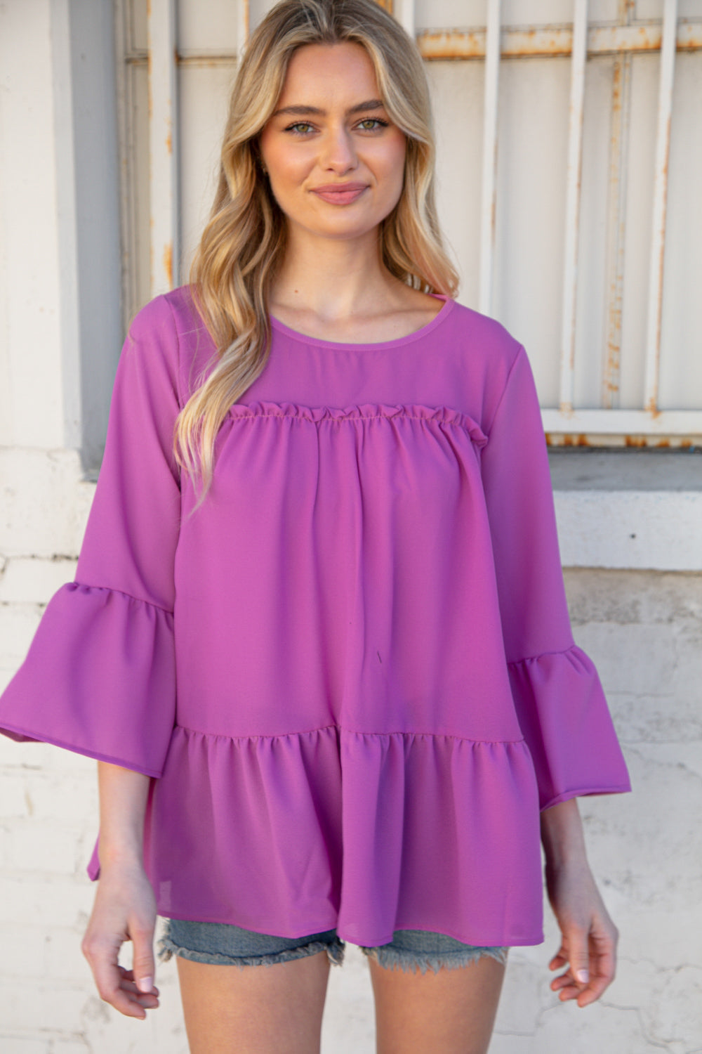 Orchid Round Neck Frill Detail Crepe Blouse featuring a frill yoke and bell sleeves, perfect for stylish outings.