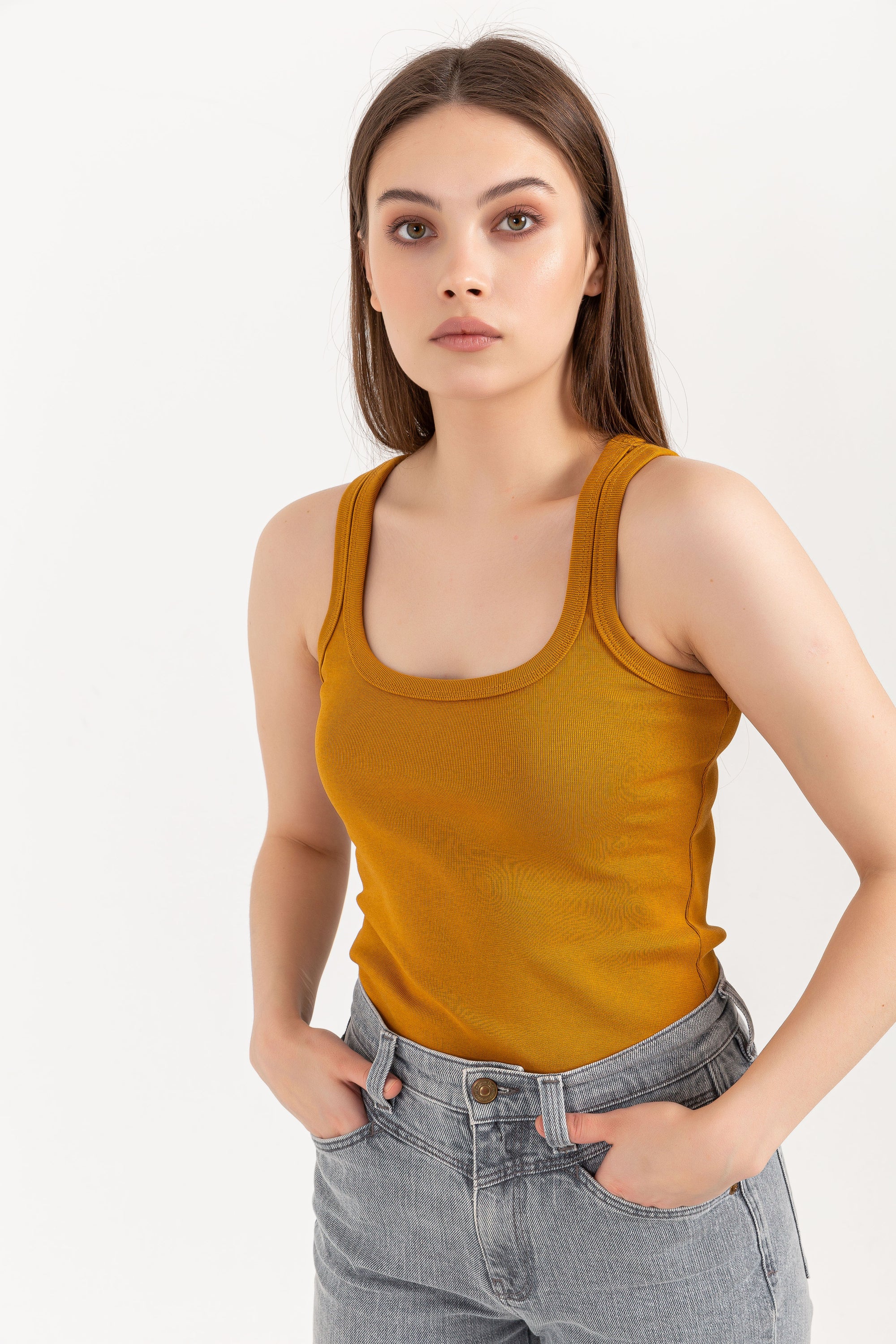 A stylish Organic Tank Top featuring a square neck design, made from 95% organic cotton and 5% elastane, displayed on a model.