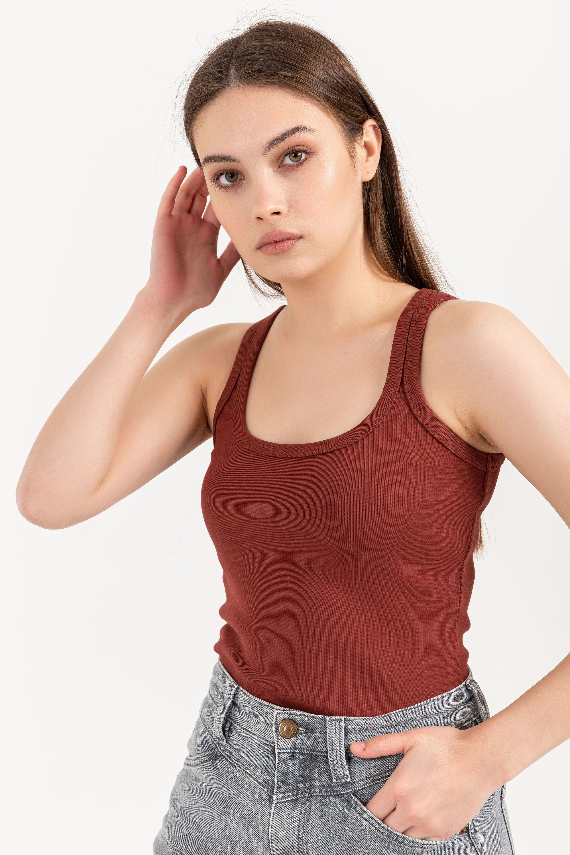 A stylish organic tank top with a square neck design, made from 95% organic cotton and 5% elastane, displayed on a model.