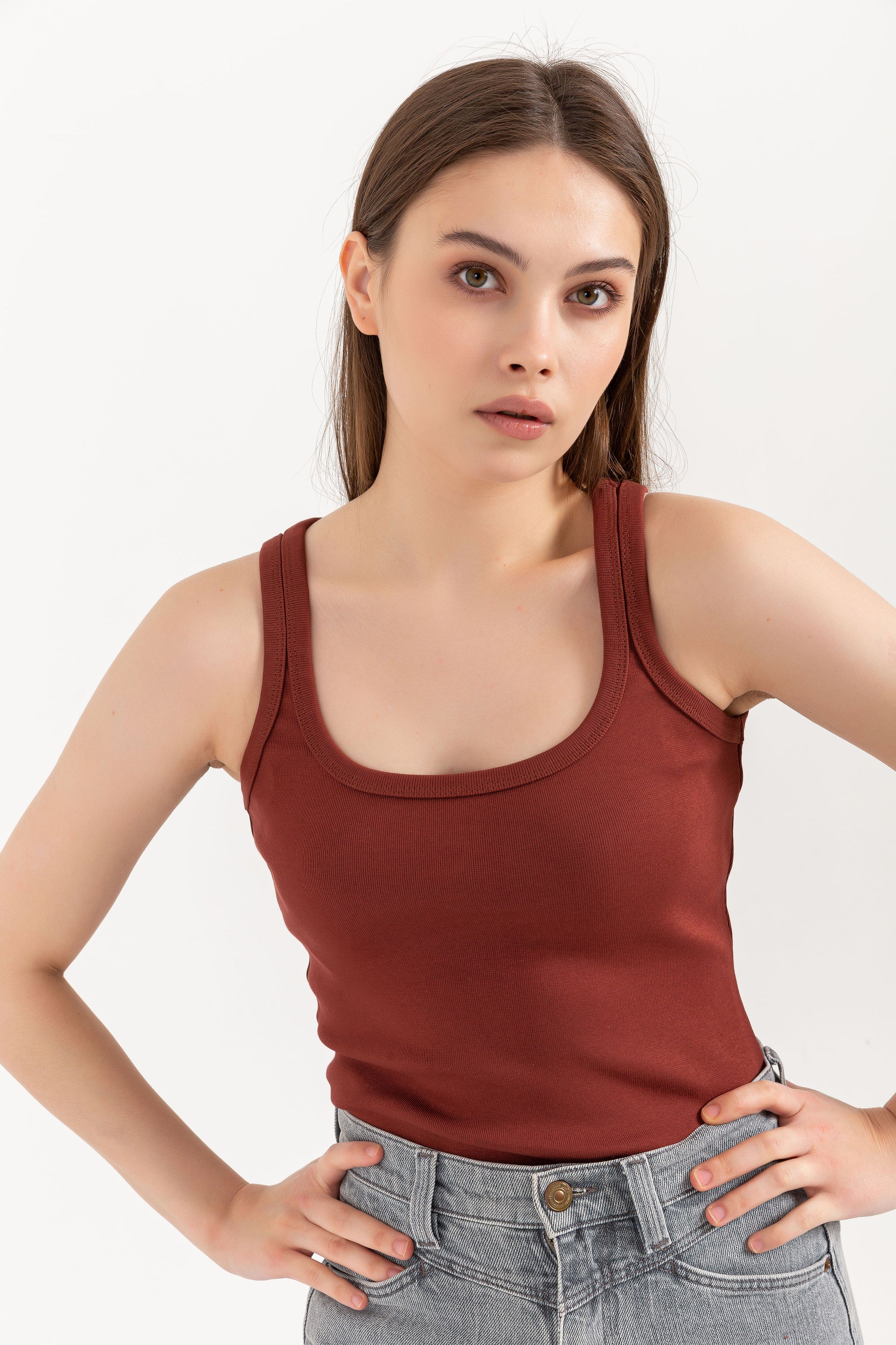 A stylish organic tank top with a square neck design, made from 95% organic cotton and 5% elastane, displayed on a model.