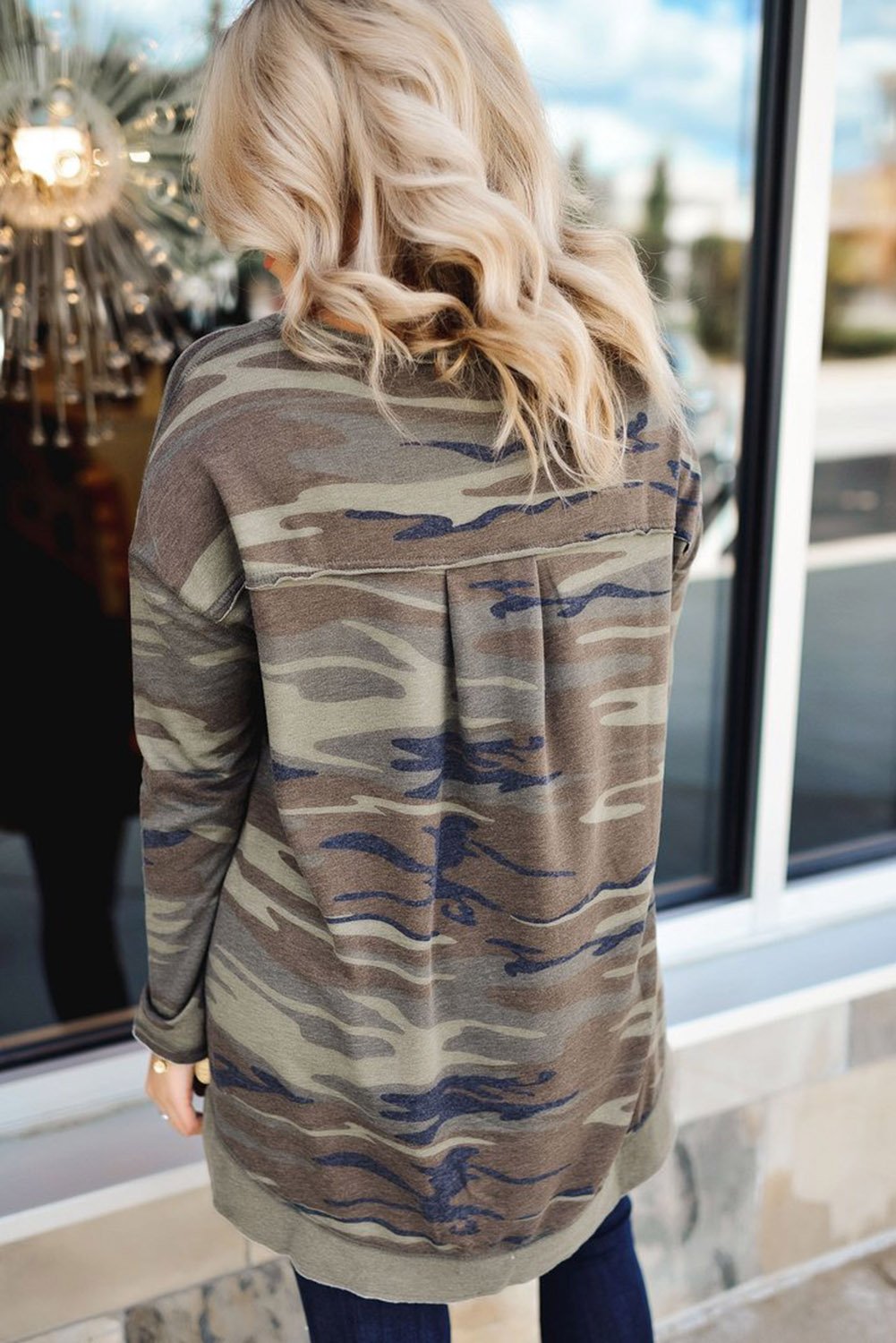 Oversize camo print sweatshirt featuring side slits and a hi-lo hemline, perfect for casual wear.