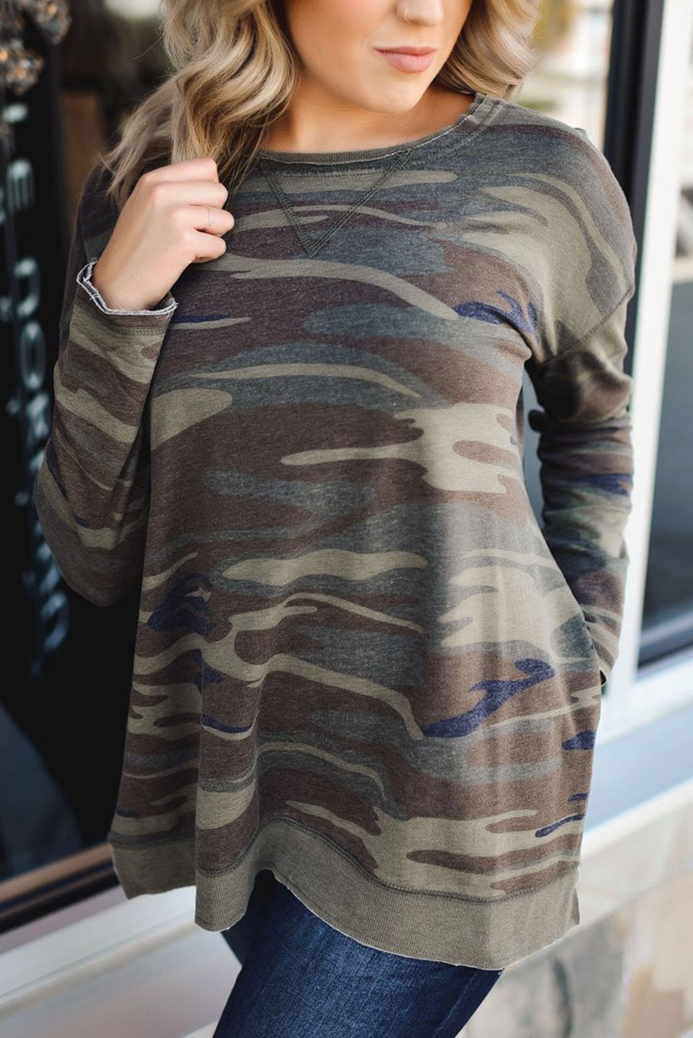 Oversize camo print sweatshirt featuring side slits and a hi-lo hemline, perfect for casual wear.