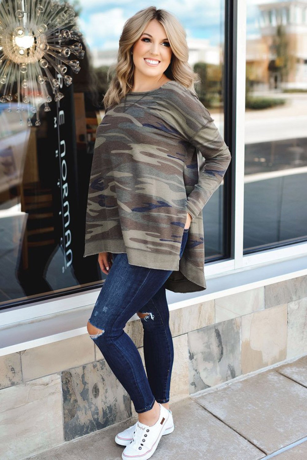 Oversize camo print sweatshirt featuring side slits and a hi-lo hemline, perfect for casual wear.