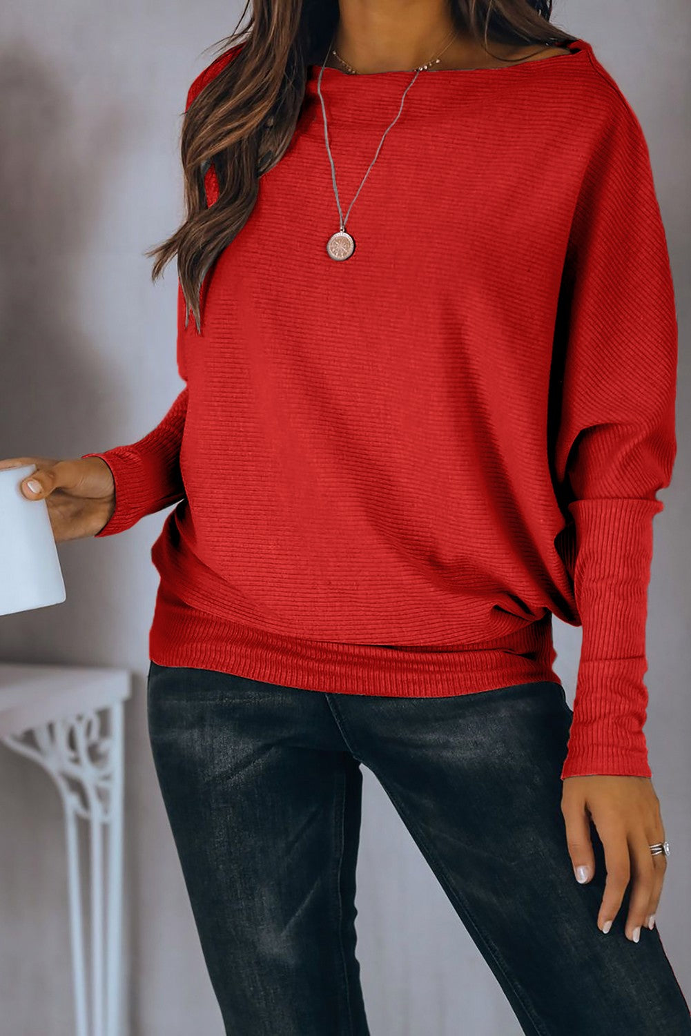 Red oversize T-shirt with boat neckline and loose sleeves, showcasing a stylish and comfortable design.