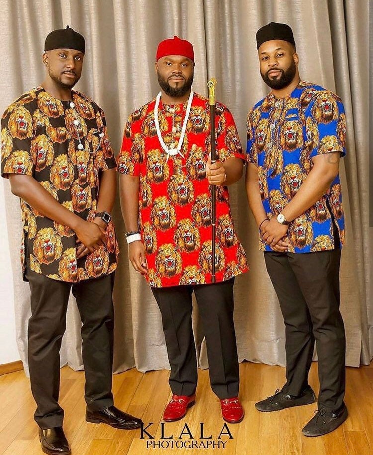 Ozo African Men set featuring a traditional Isiagu shirt in vibrant colors with gold buttons and a breast pocket, accompanied by a red fez hat.