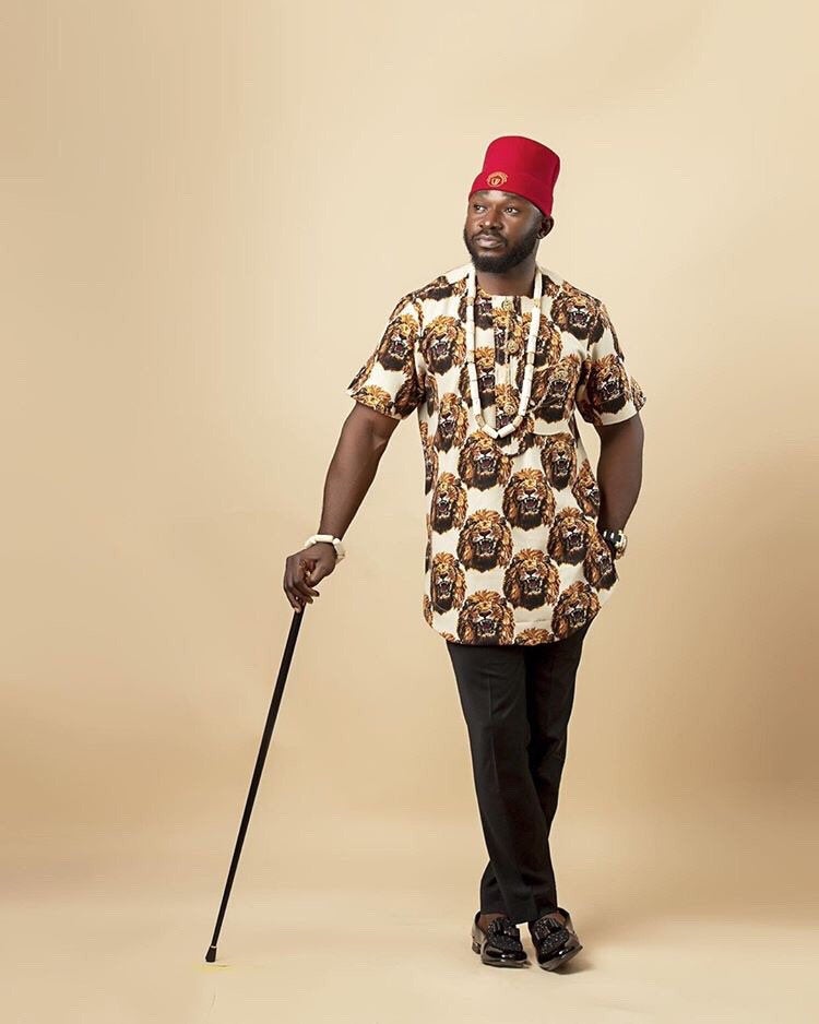 Ozo African Men set featuring a traditional Isiagu shirt in vibrant colors with gold buttons and a breast pocket, accompanied by a red fez hat.