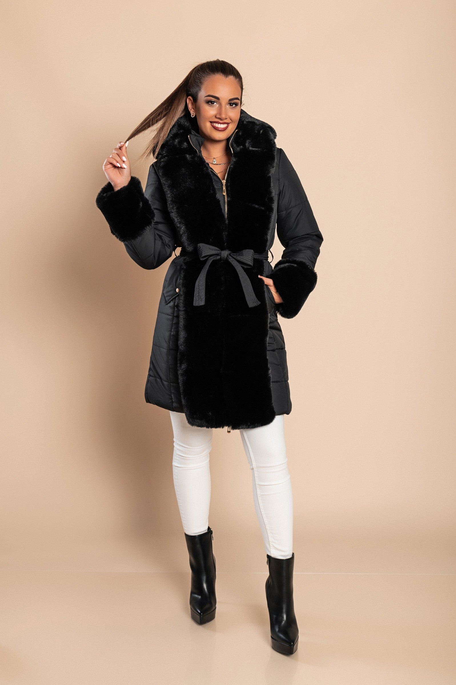 Black padded jacket with faux fur trim, featuring a metal zipper, side pockets, and a belt, designed for warmth and style.