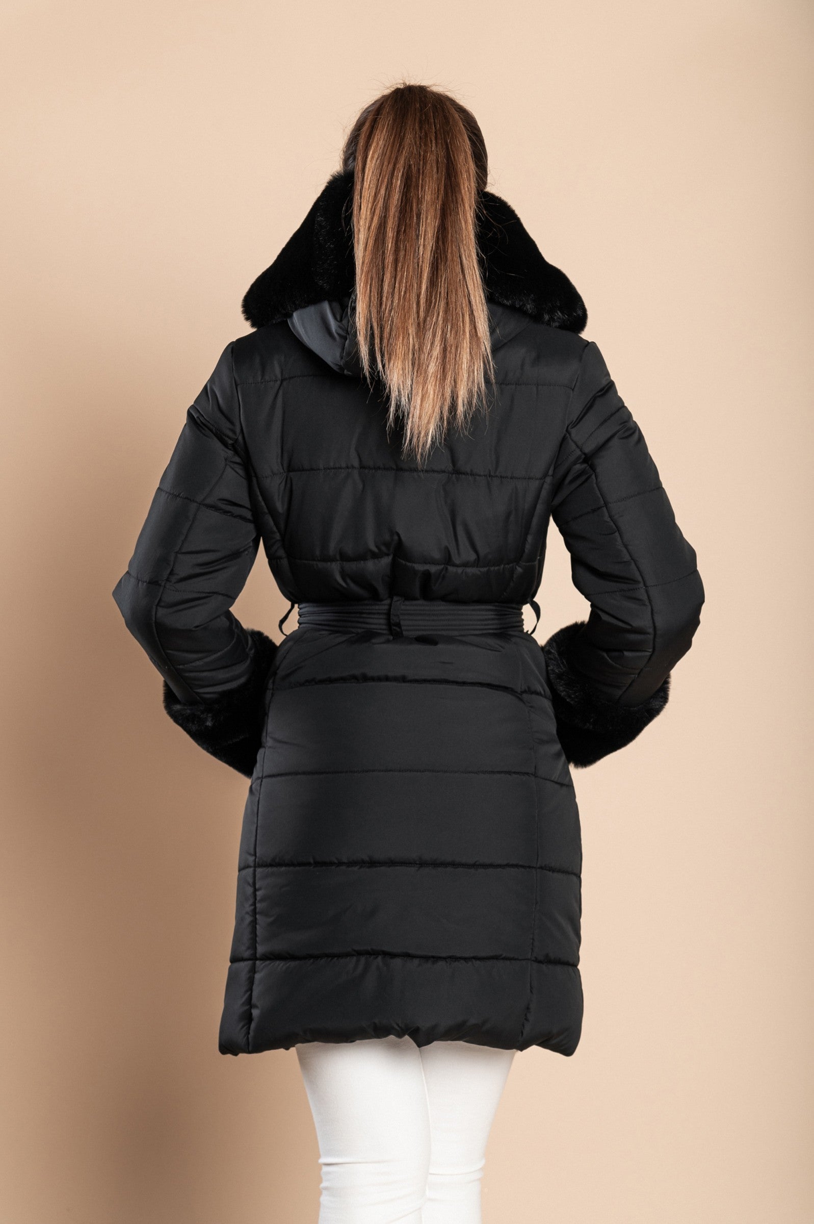 Black padded jacket with faux fur trim, featuring a metal zipper, side pockets, and a belt, designed for warmth and style.