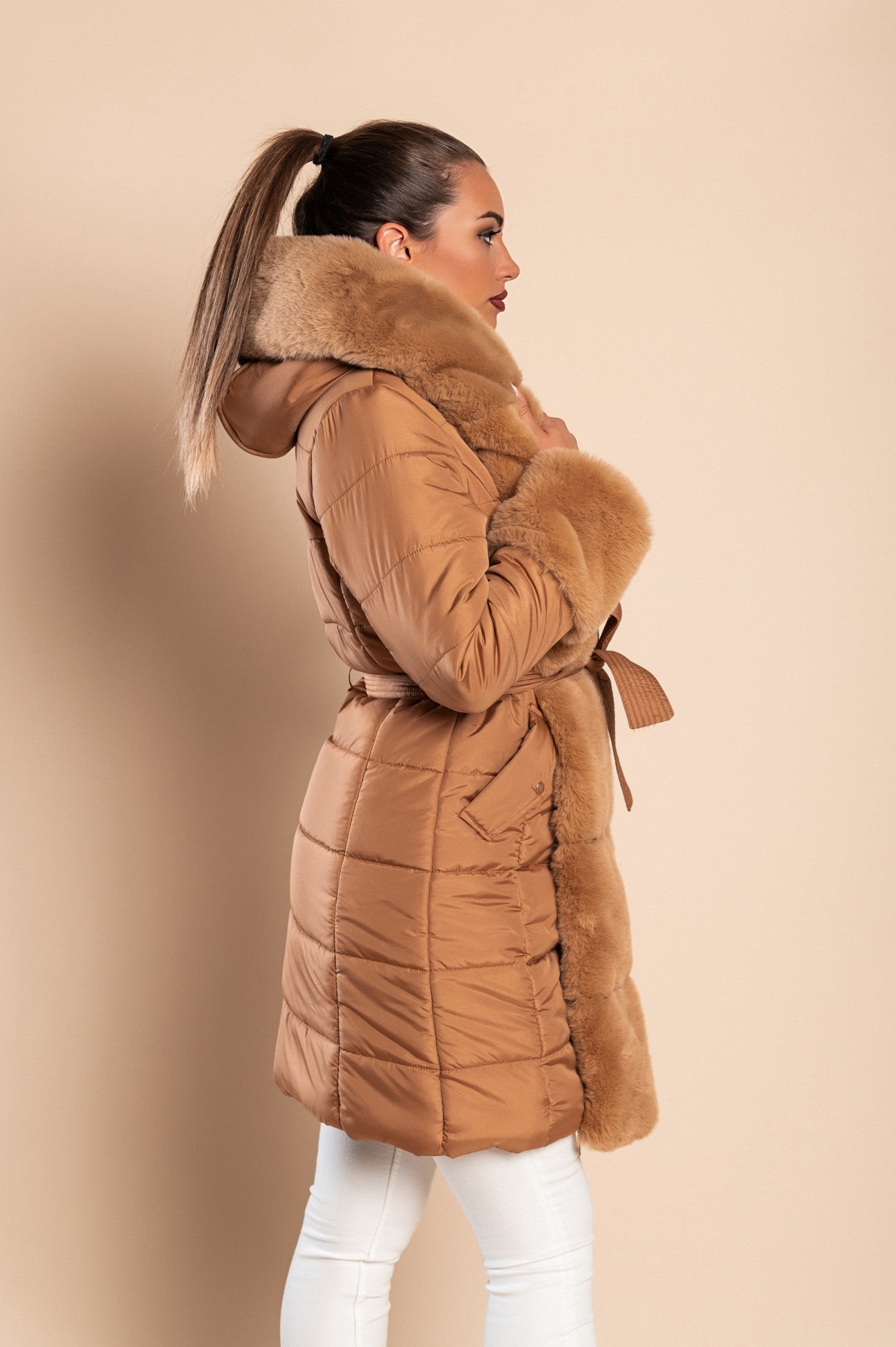 Camel padded jacket with faux fur trim, featuring a quilted design, side pockets, and a metal zipper closure.