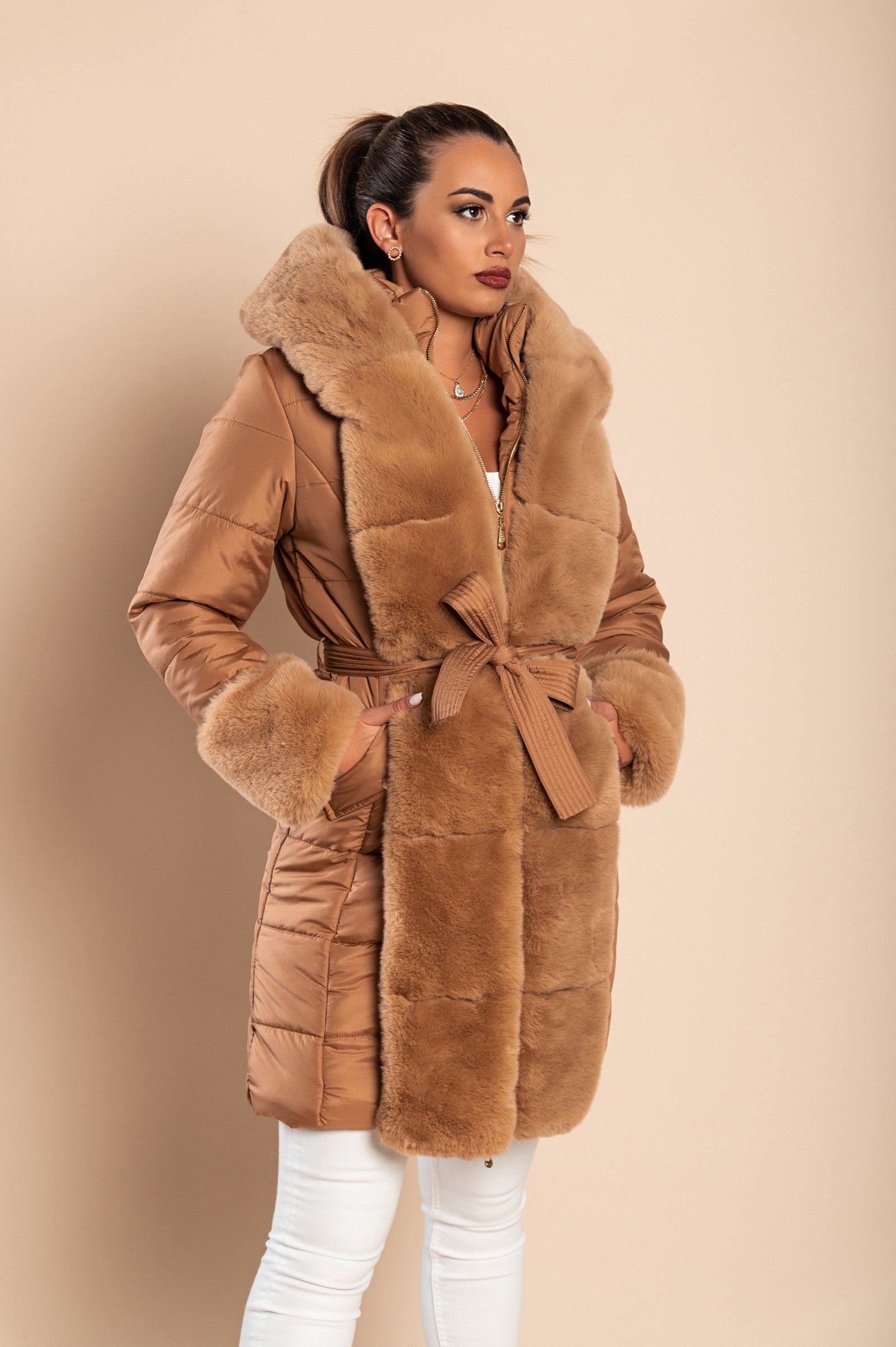 Camel padded jacket with faux fur trim, featuring a quilted design, side pockets, and a metal zipper closure.