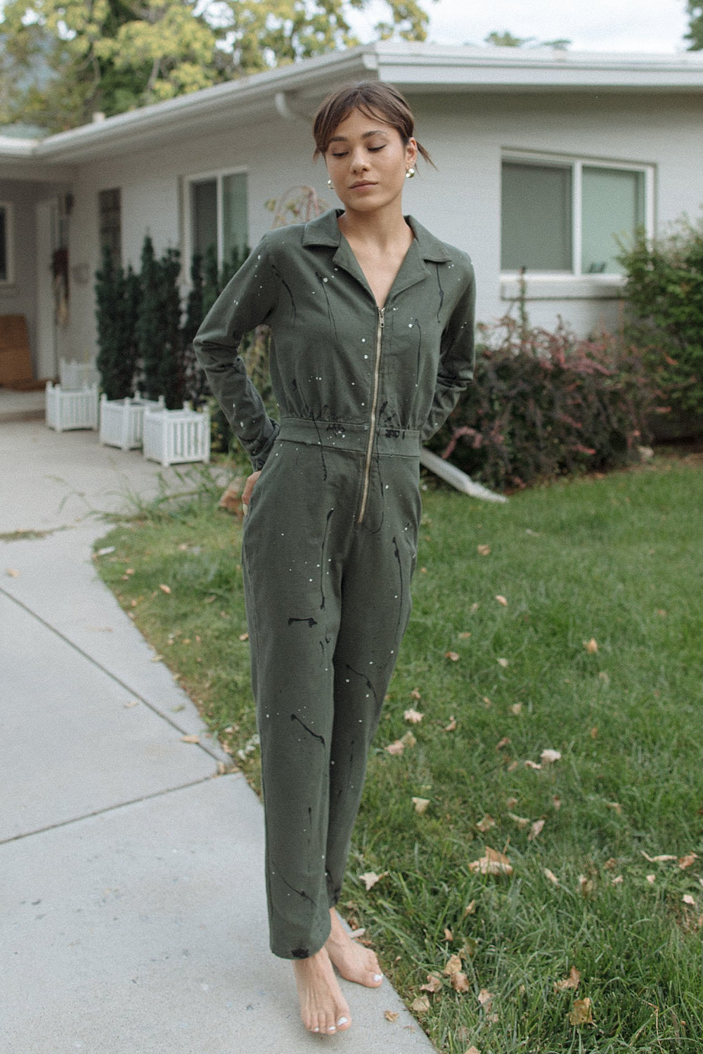 A stylish Painter Jumpsuit in indigo and olive colors, made from 100% organic cotton, showcasing its relaxed fit and comfortable design.