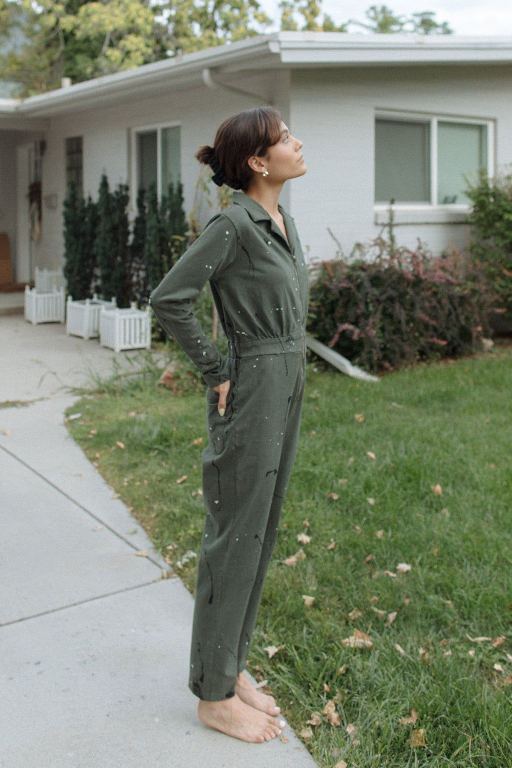 A stylish Painter Jumpsuit in indigo and olive colors, made from 100% organic cotton, showcasing its relaxed fit and comfortable design.