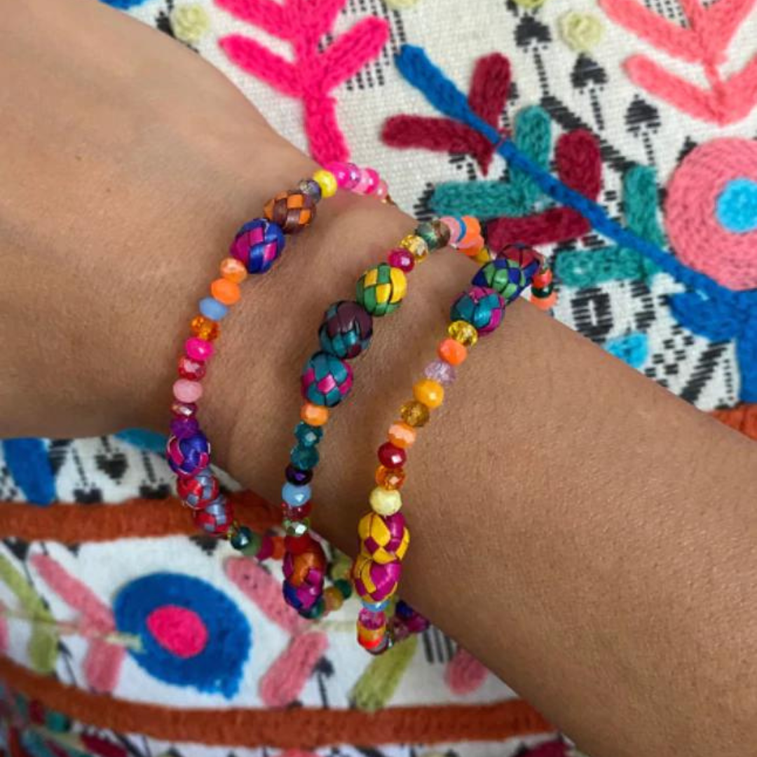 Colorful handcrafted Palm Bracelet made from dyed palm beads, showcasing vibrant patterns and artisan craftsmanship.