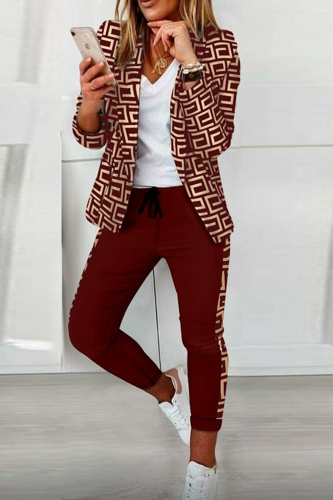 Burgundy pant set featuring a stylish geometric print blazer and fitted pants with elastic waist and drawstring.