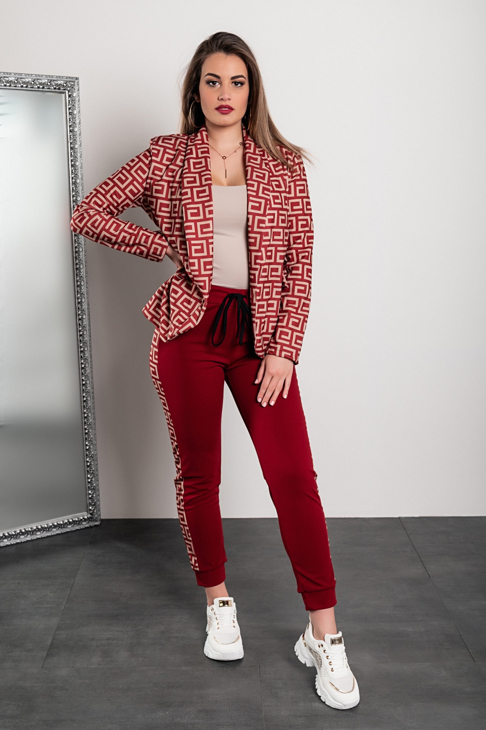 Burgundy pant set featuring a stylish geometric print blazer and fitted pants with elastic waist and drawstring.