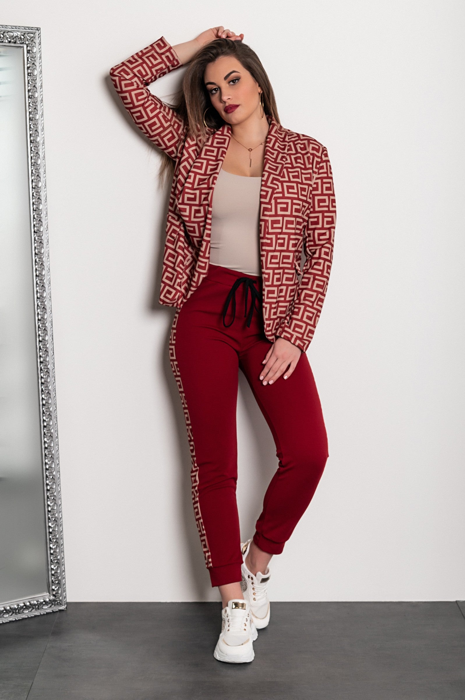 Burgundy pant set featuring a stylish geometric print blazer and fitted pants with elastic waist and drawstring.