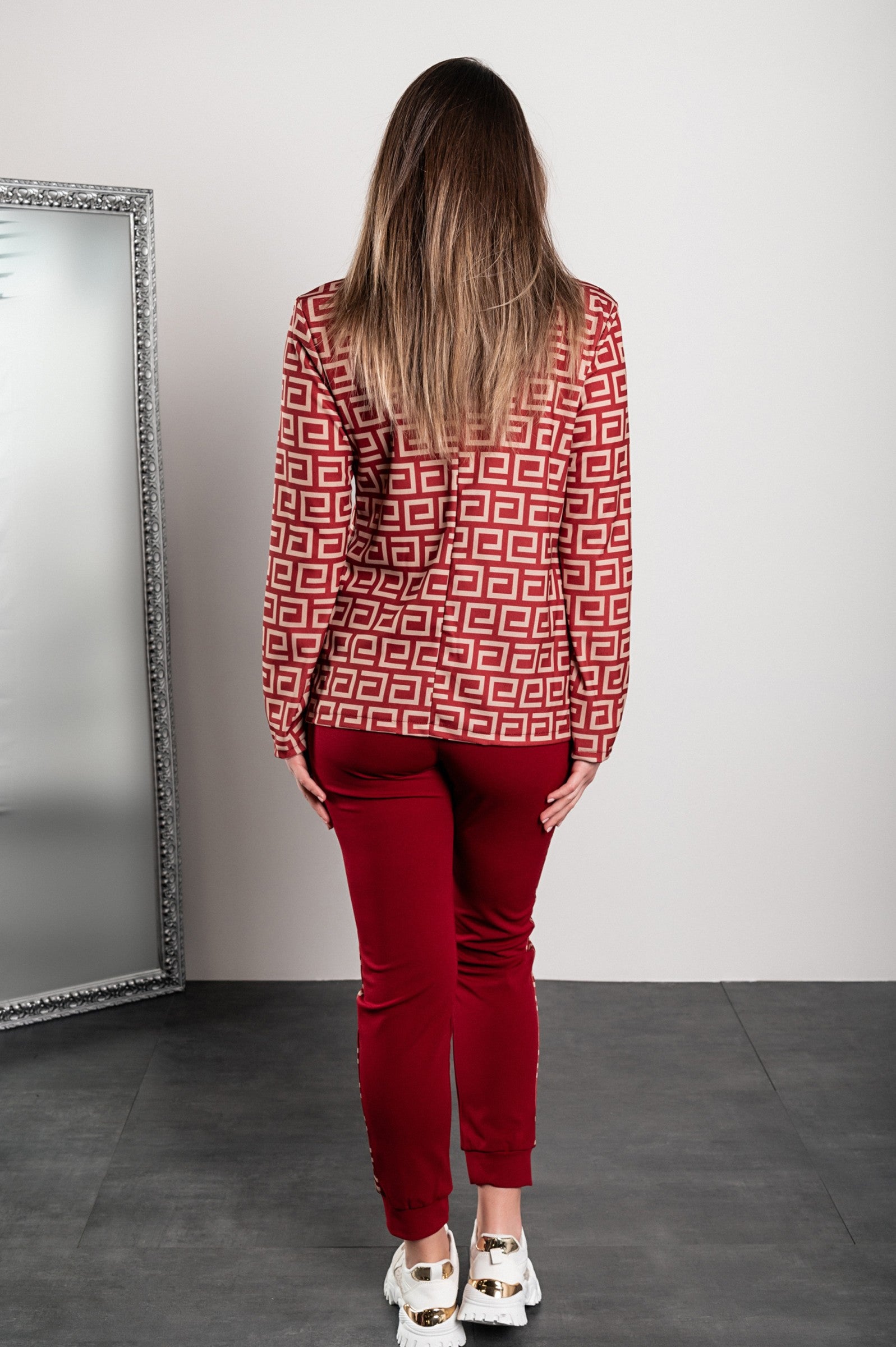 Burgundy pant set featuring a stylish geometric print blazer and fitted pants with elastic waist and drawstring.