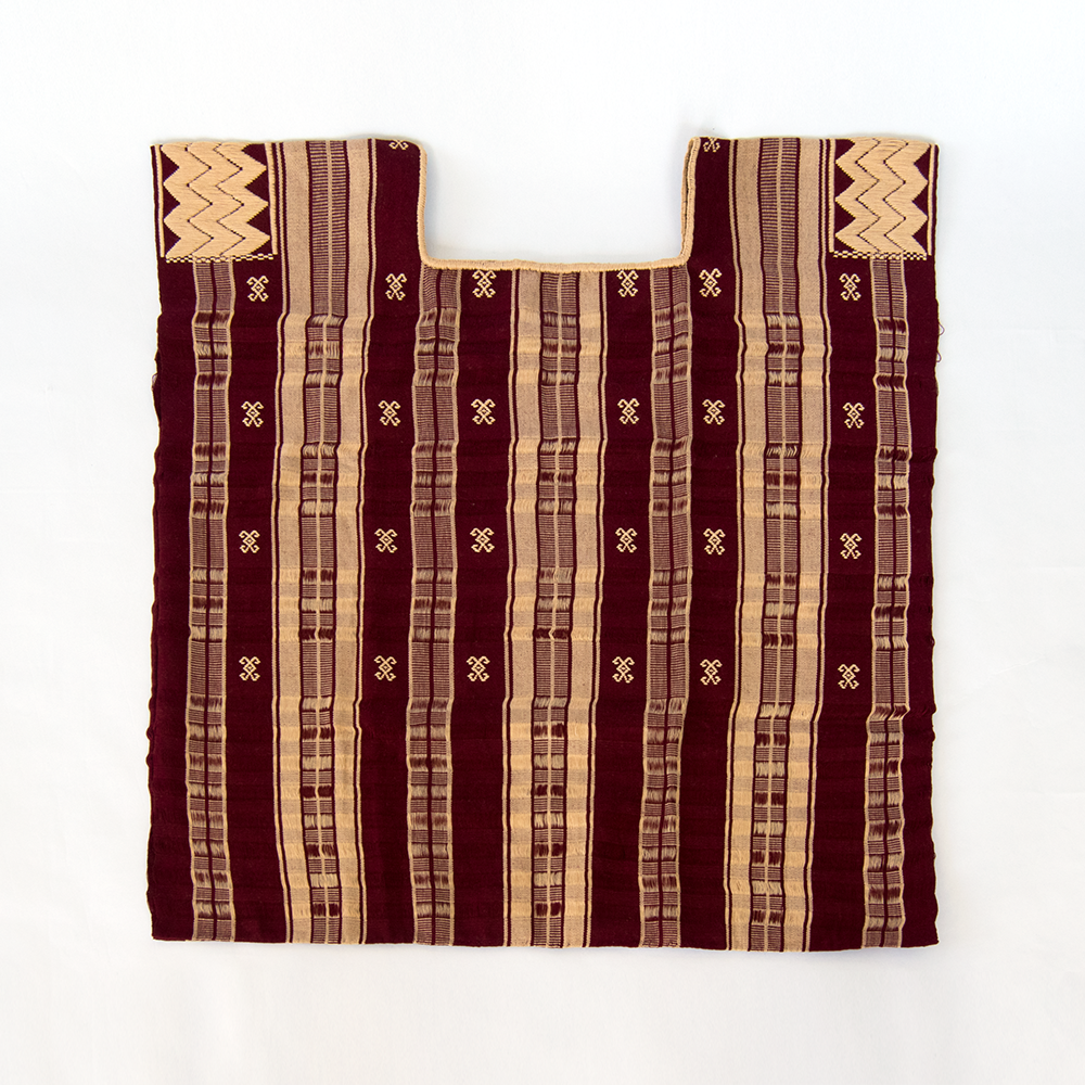 A beautiful handmade huipil in burgundy with beige stripes, showcasing traditional Mexican craftsmanship and design.