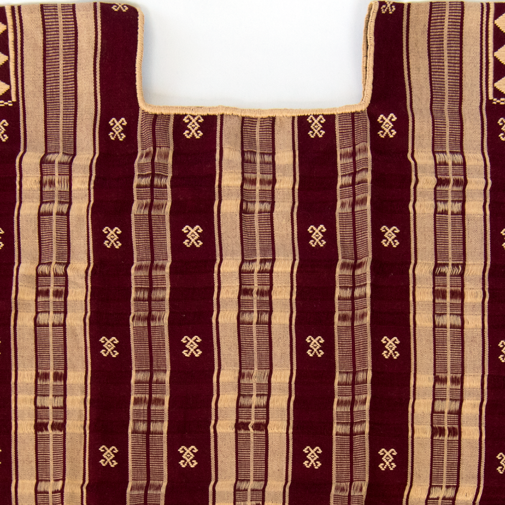 A beautiful handmade huipil in burgundy with beige stripes, showcasing traditional Mexican craftsmanship and design.